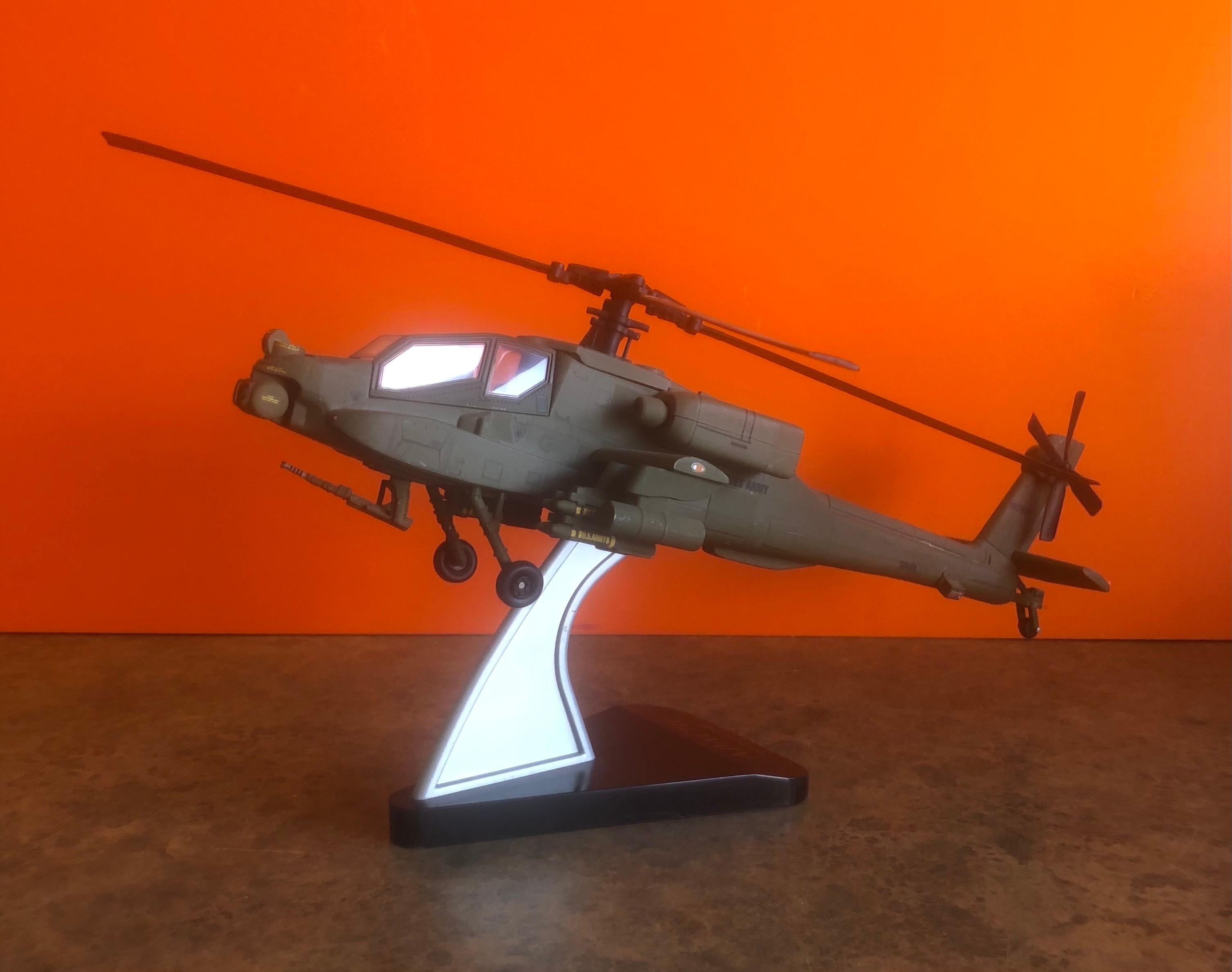 A very cool Blawkhawk helicopter desk model, circa 2000s. The piece is in very good condition and super high quality with great detail. The helicopter is 1:40 scale and made of molded plastic and mounted on a triangular base. #1371
