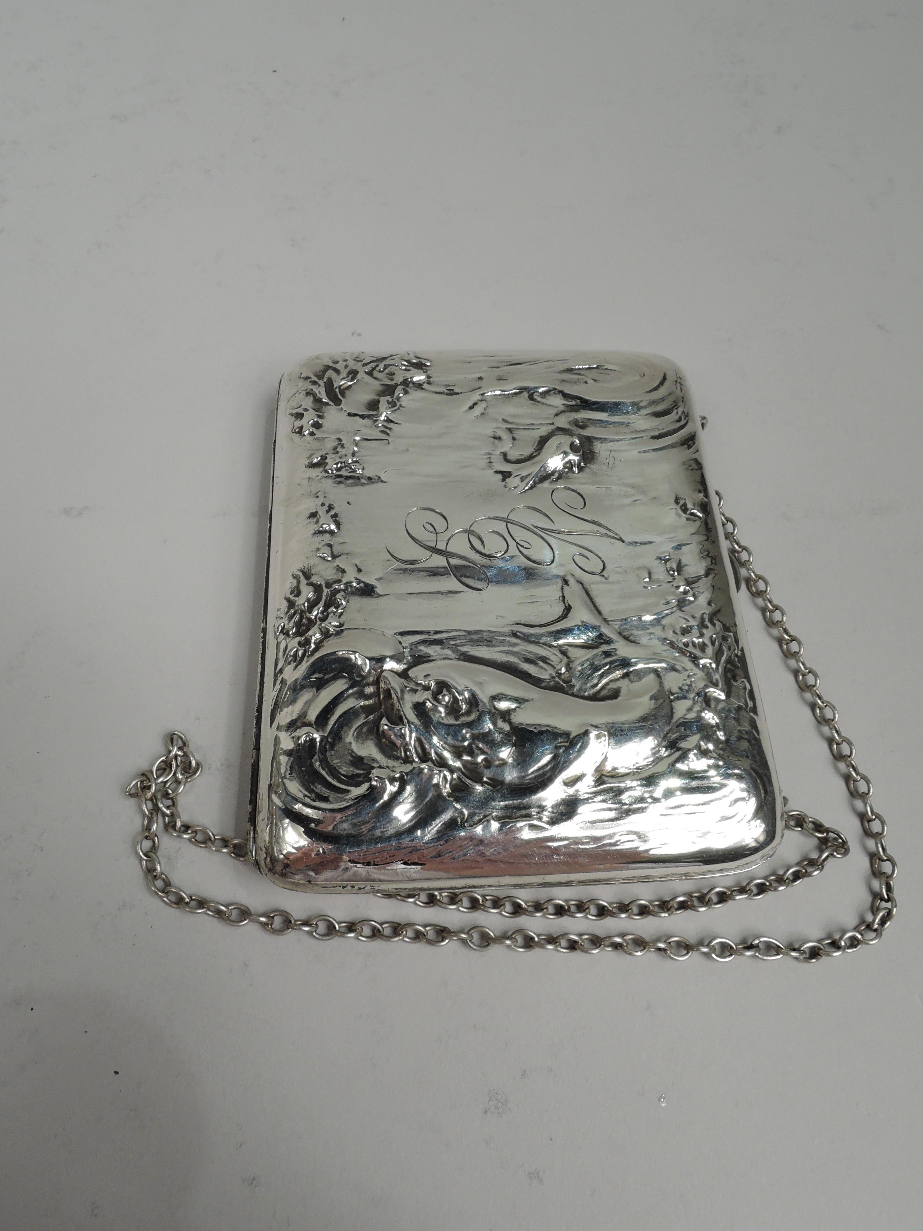 Turn-of-the-century Art Nouveau sterling silver cigarette case. Made by Blackinton in North Attleboro, Mass. Rectangular and hinged. On front and back is same marine scene with whiplash currents and seagrass. At bottom is a big tail-lashing fish,