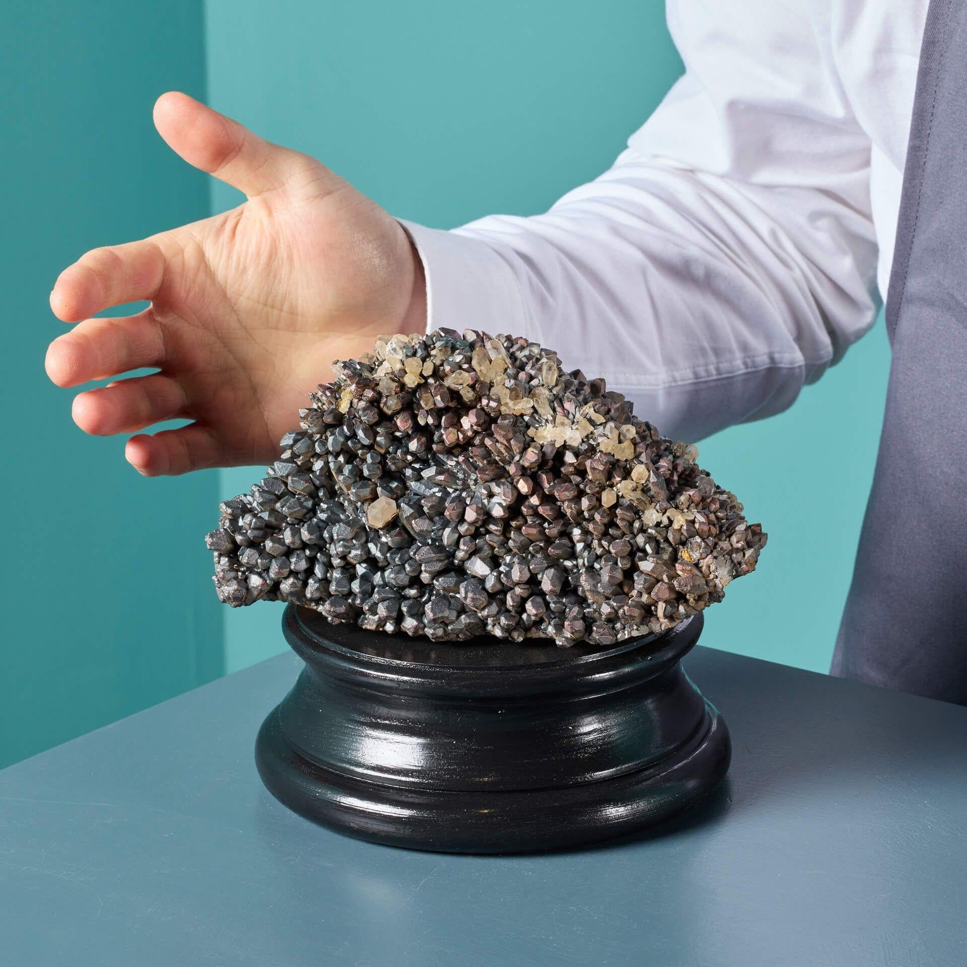 An unusual blacknite quartz cluster specimen with covelline and bornite from Ambositra, Madagascar, presented on one of our museum-quality painted plaster bases. This striking and unusual specimen comes with an exclusive painted plaster plinth as