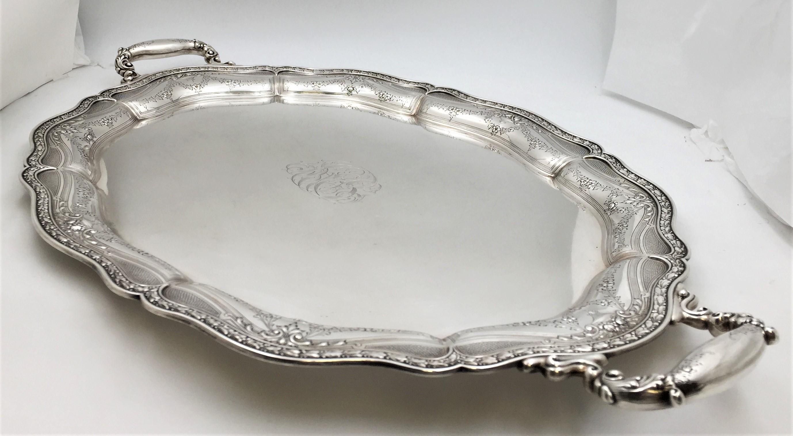 Black, Starr & Frost, 2-handled, sterling silver bar tray (with heavy gauge) in Art Nouveau style with the border chased with foliate swags, flowers, and other beautiful motifs. It measures 30 1/4'' in length from handle to handle (26'' within) by