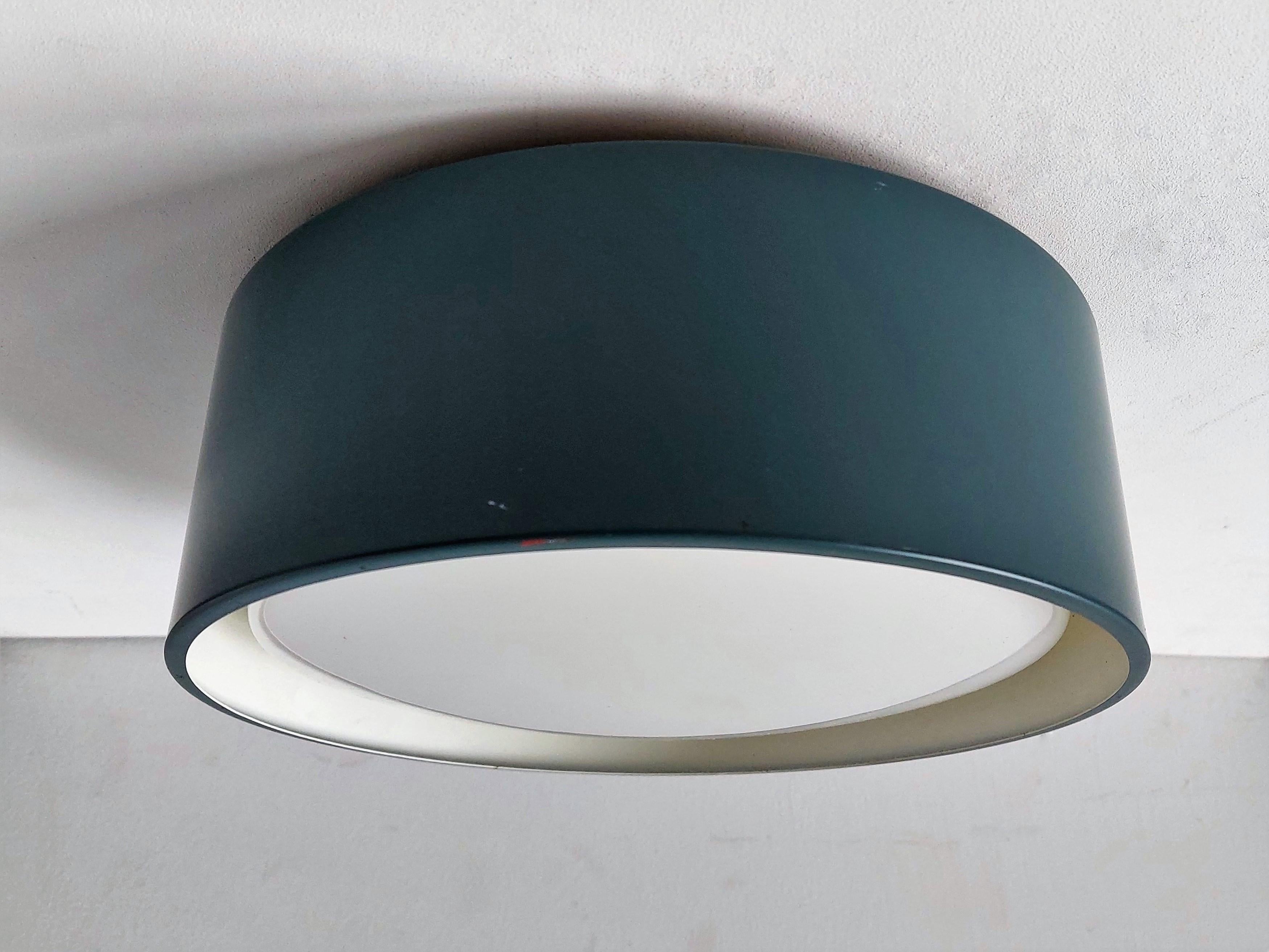 This ceiling lamp was designed by the architects Karen and Ebbe Clemmensen & Jørgen Bo for Fog & Mørup in the 1960's. It is part of the Blågård series and has a petrol blue original lacquered shade with an acrylic diffuser for a beautiful