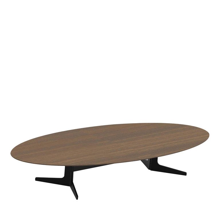 A clean, essential design marks this simple yet stunning coffee table. Its large, oval top is crafted of smoked oak with a brown finish and superbly rests on a metal base featuring two legs connected by a horizontal bar and enriched with feet,