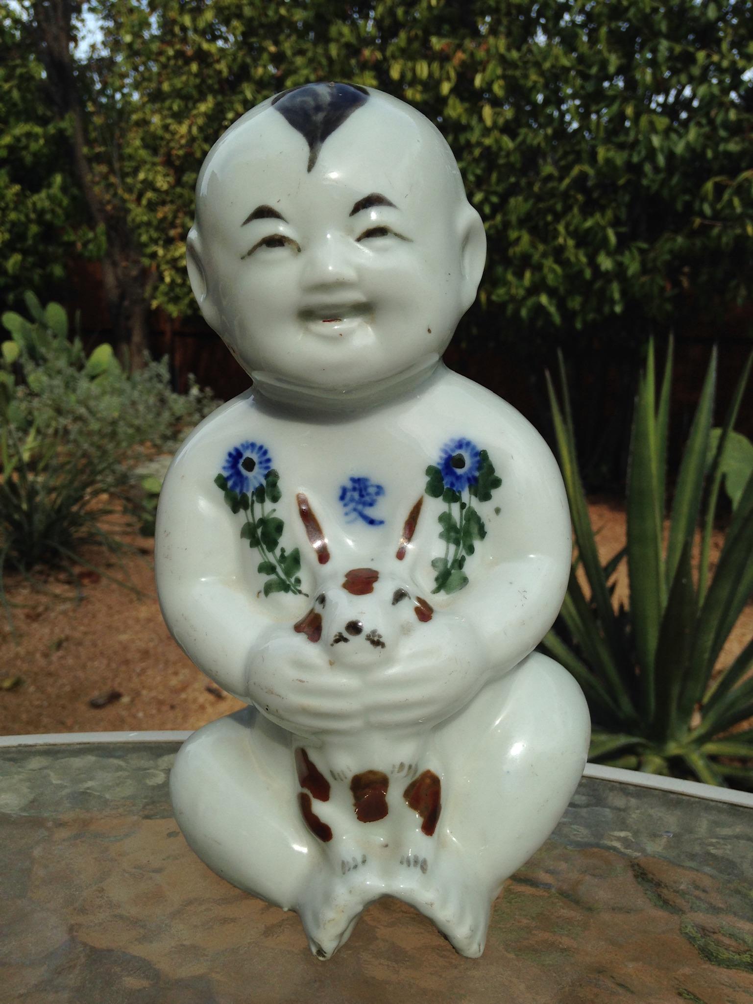 Blanc De Chine Baby Buddha with Rabbit.

19th century chinese figure statue of baby buddha smiling while carring a rabbit. Rare in that there are colors,

This was purchased in Beijing at a government antique store in 1981 and has the official