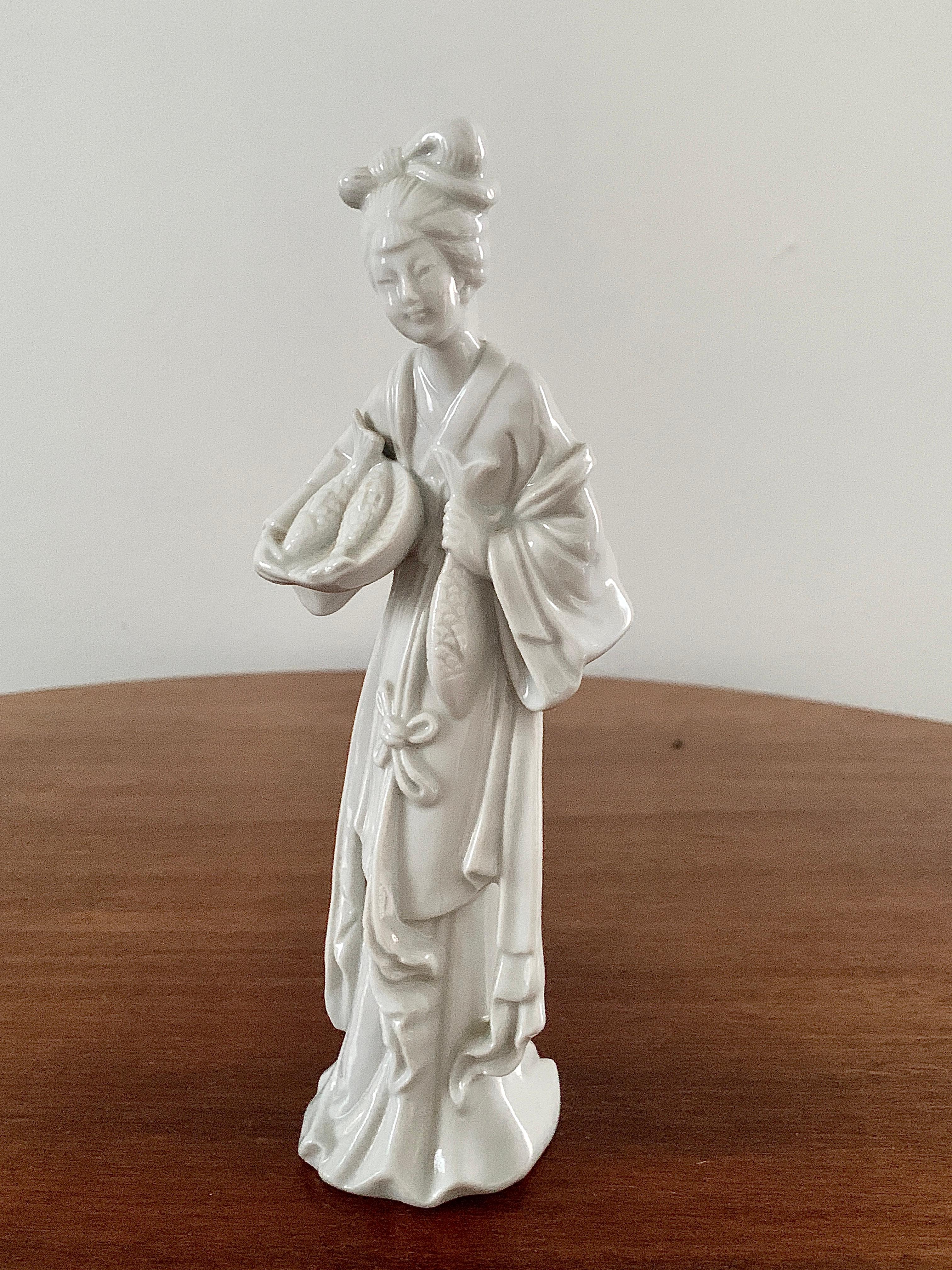 A gorgeous blanc de chine porcelain Chinese woman holding a basket of fish

Circa mid-20th century

Measures: 3