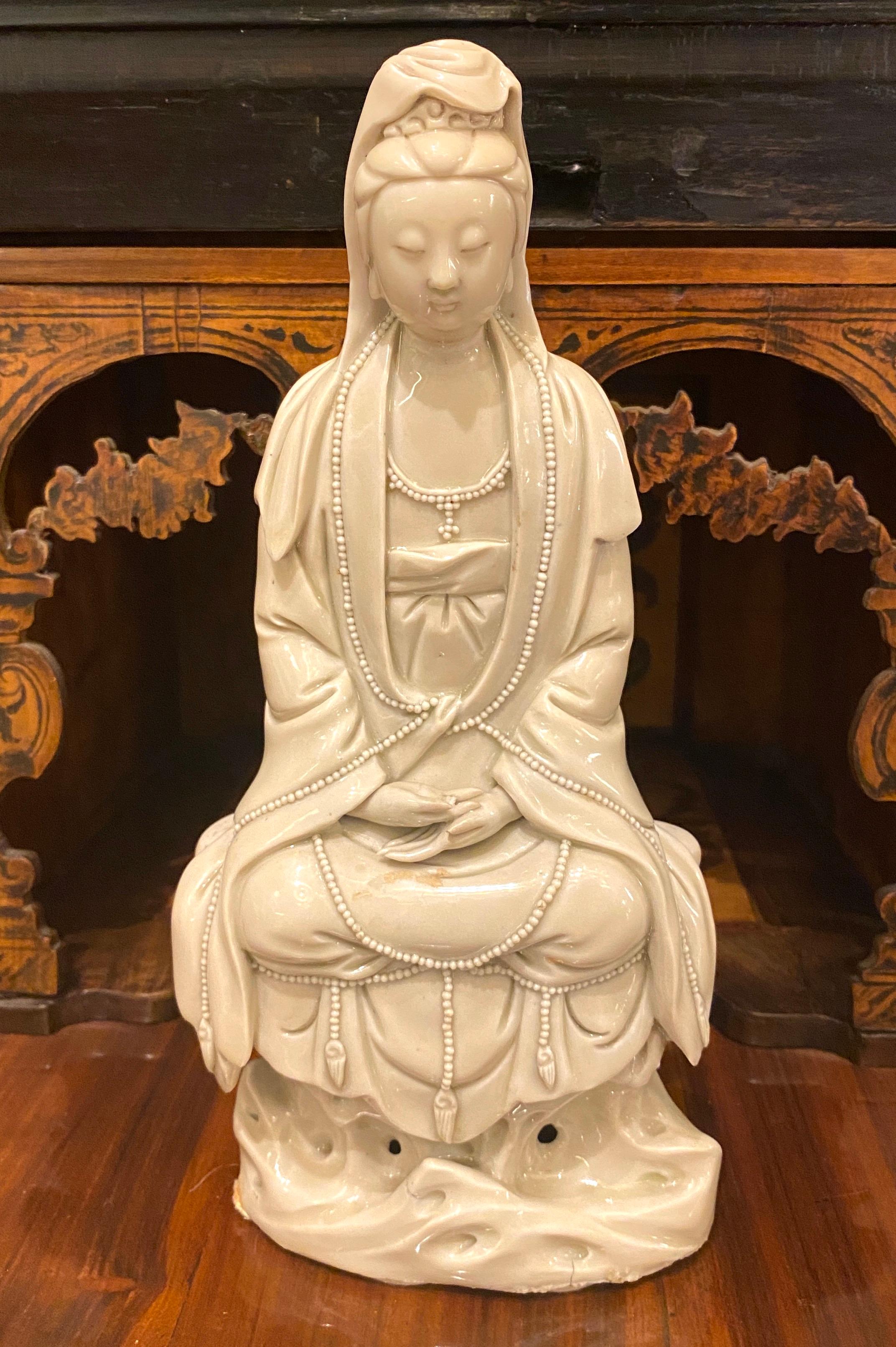 A Blanc-de Chine Figure of Guanyin  Qing Dinasty 
seating on a the waves, the arms lifted to the waist, dressed in loose fitting robes opening at the chest to reveal a necklace, applied with an ivory glaze.
cm 25 x13.
 Proveniance Leo Veneziani