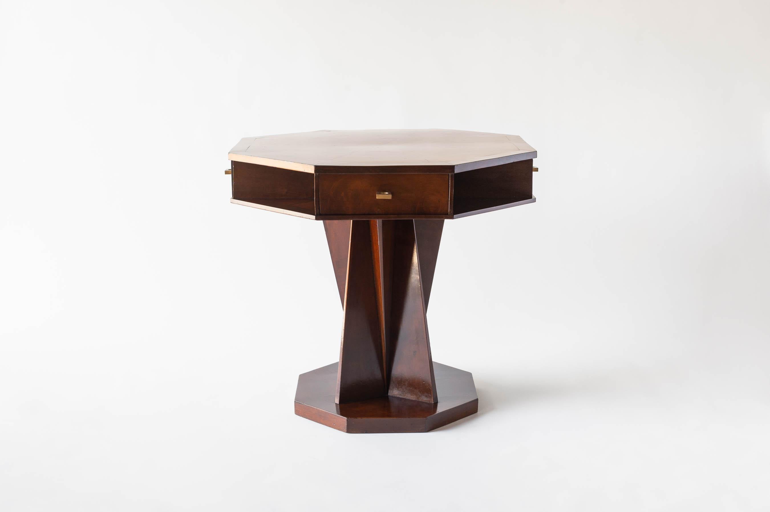Table d'appoint en placage d'acajou conçue par Blanche Klotz (1885- ?) à la fin des années 1920. Un plateau octogonal avec 4 tiroirs et 4 étagères inférieures se trouve au-dessus d'un socle composé d'angles croisés, ce qui ajoute à la forme cubiste