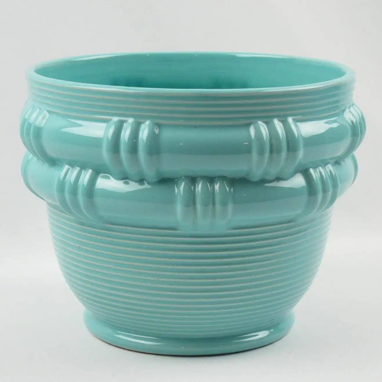 This stylish 1950s ceramic vase or planter was hand-crafted by ceramicist Blanche Letalle for Faiencerie Saint-Clement, France. The piece boasts a lovely turquoise glaze with a basketry pattern. Blanche Letalle was a recognized French