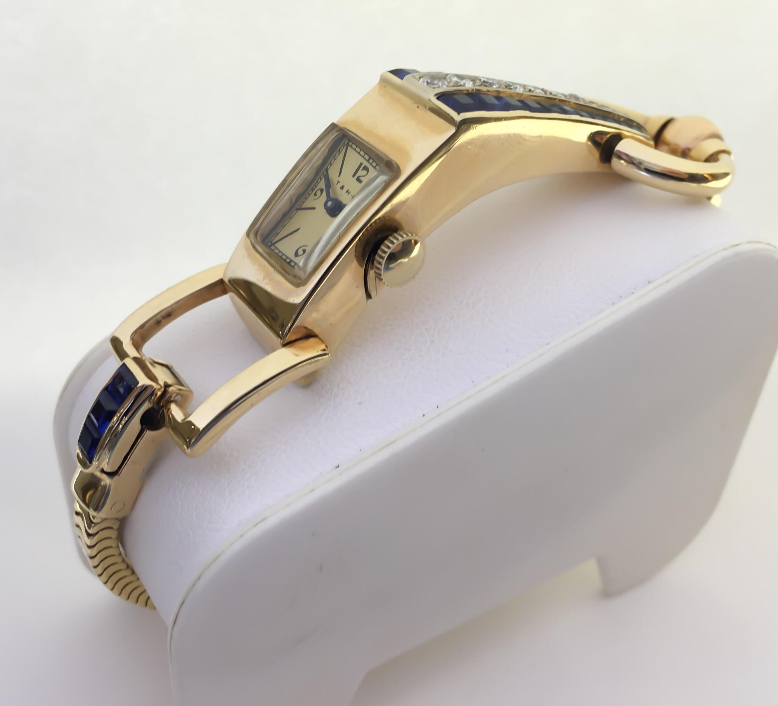 Special retro 1940's ladies Blancpain watch designed in 14 karat yellow gold. Snake chain with polished center bar for potential sizing. Fold over clasp contains square sapphires and connects to square open link near case. 

•MOVEMENT: MECHANICAL