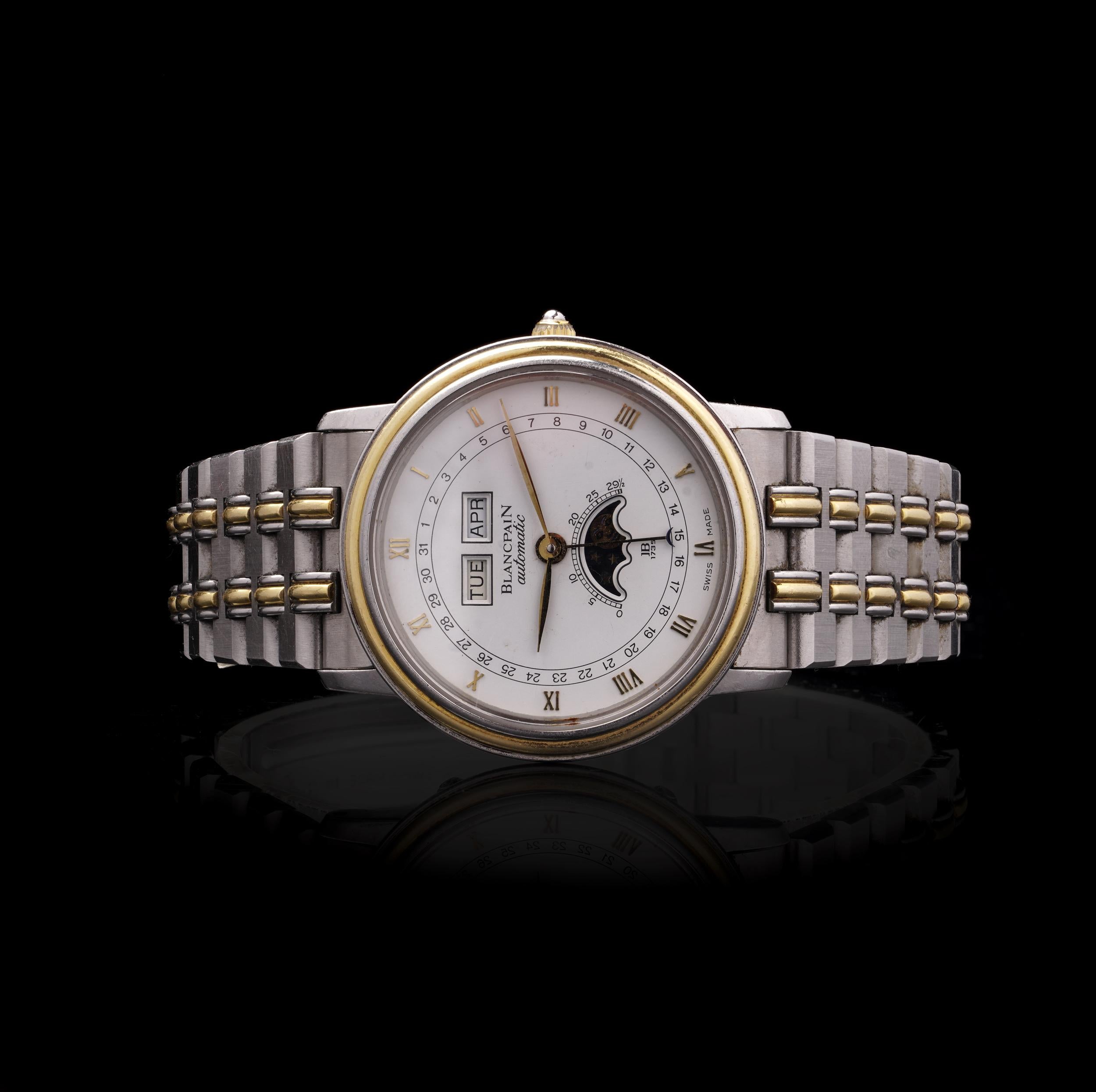 Stainless steel and yellow gold Blancpain Villeret Ref. 6595 triple calendar wristwatch with moonphase, produced circa 1990s
This elegant model features a 32mm case with a yellow gold bezel, a crisp white dial with applied Roman numerals, and