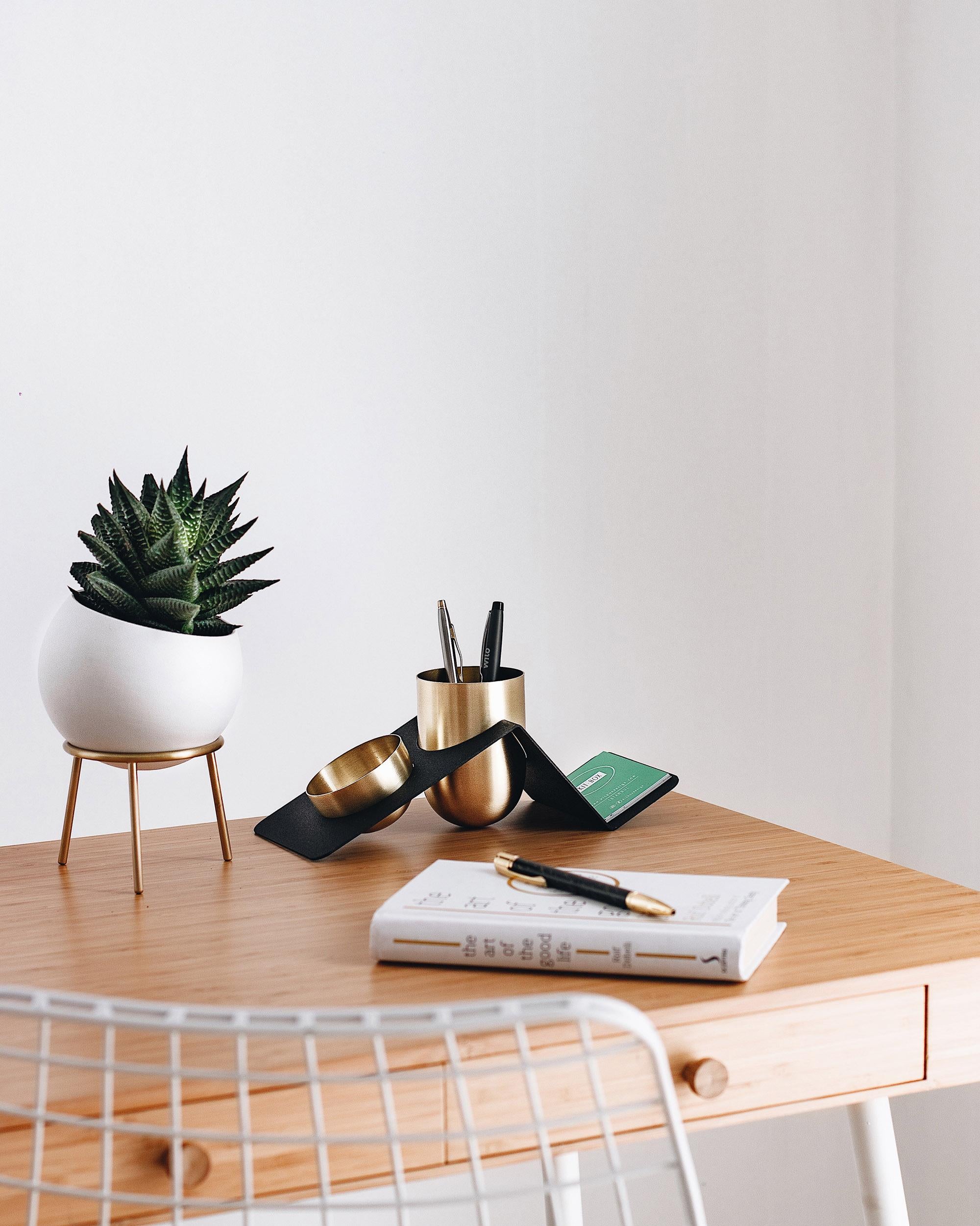 Blank Pen is a stylish and fun way of organizing your work desk. The brass or copper containers are designed in a way that cannot stand on their feet and therefore needs a little bit support from the metal stand that joins them all.

While the pen