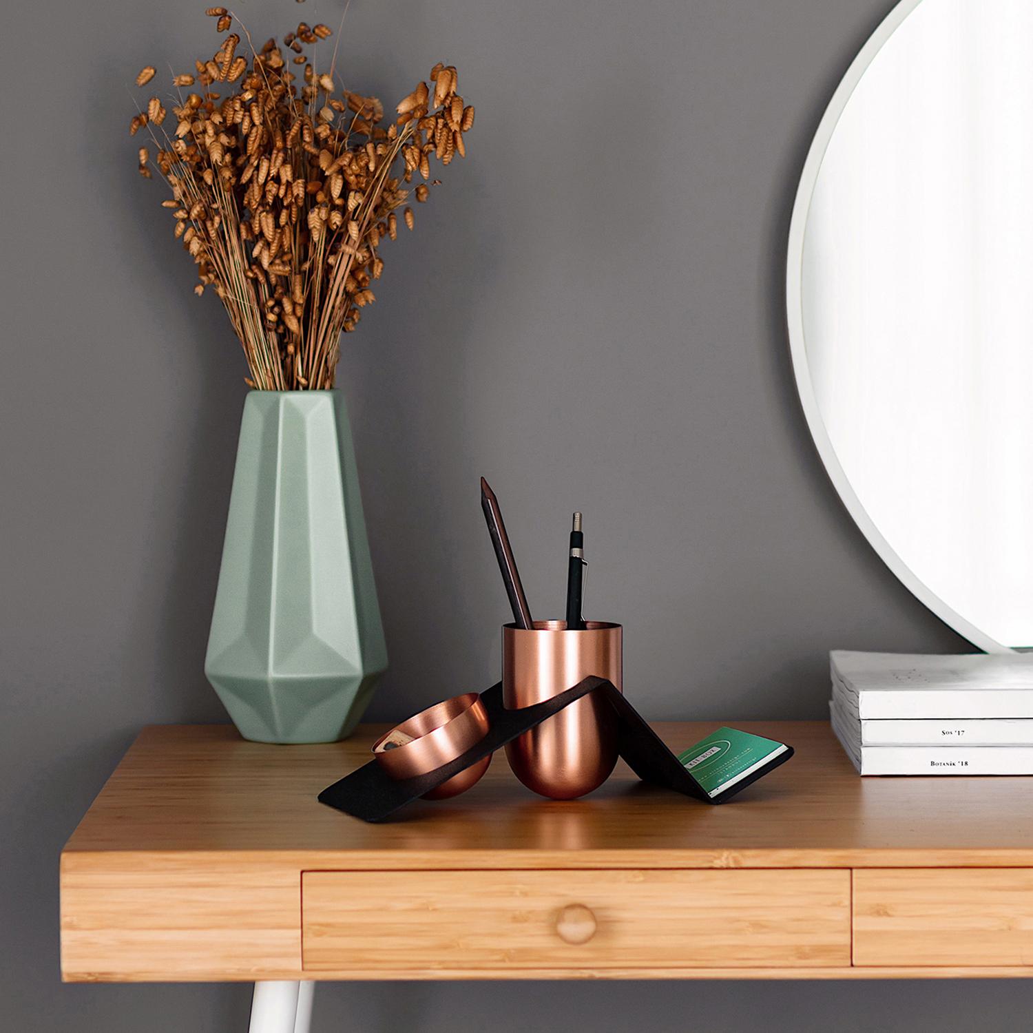 Blank Pen is a stylish and fun way of organizing your work desk. The brass or copper containers are designed in a way that cannot stand on their feet and therefore needs a little bit support from the metal stand that joins them all.

While the pen