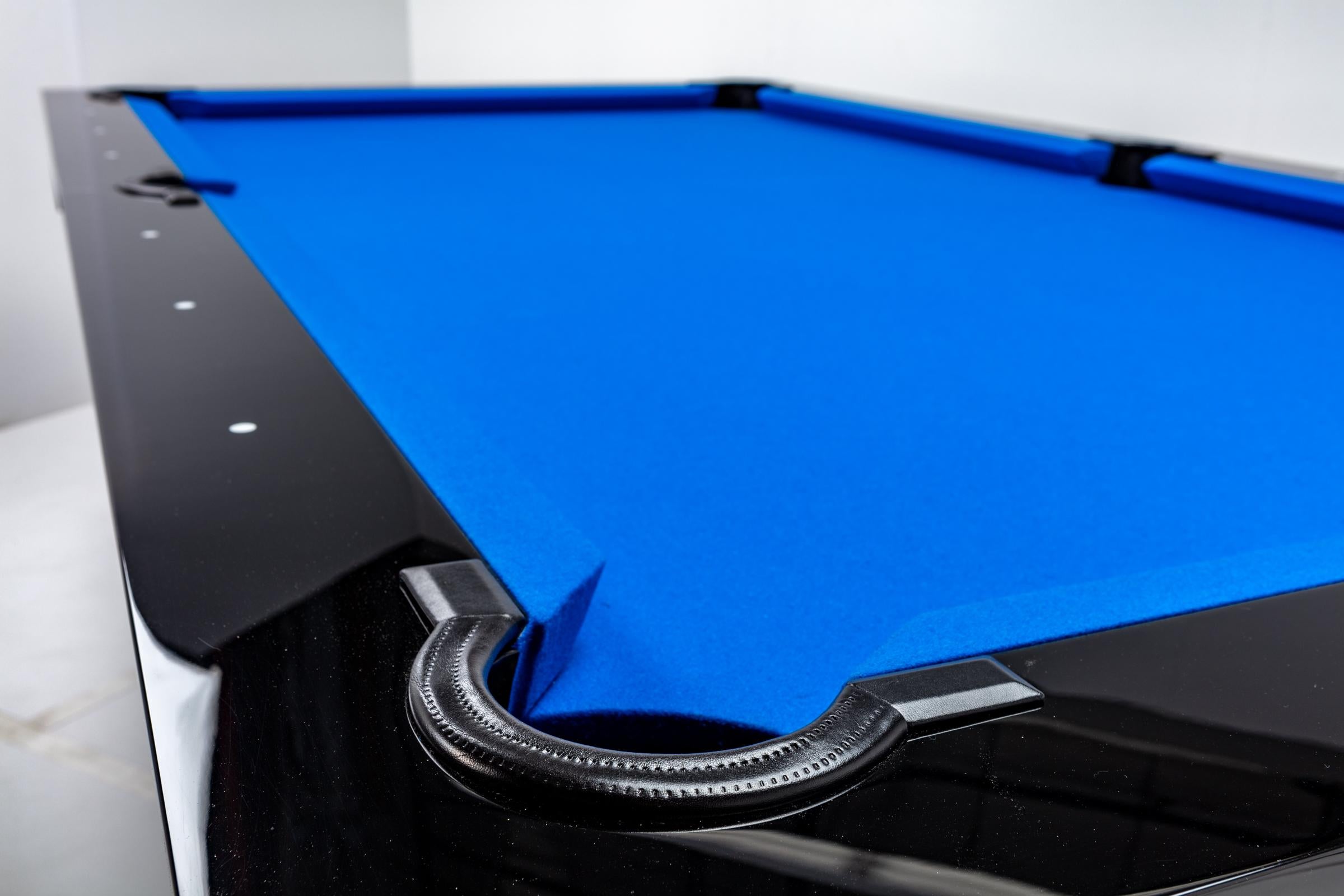 A handcrafted modern billiards table, with a hand rubbed high gloss back wood stain finish. Cloth color of choice. Endless lines for endless play.