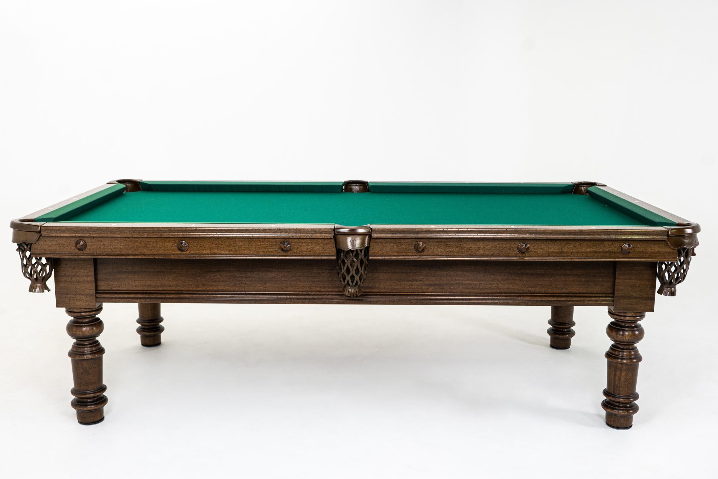 A classic billiards masterpiece. Featuring hand turned legs of solid pattern wood. Simple, yet regal designed in the United Kingdom.