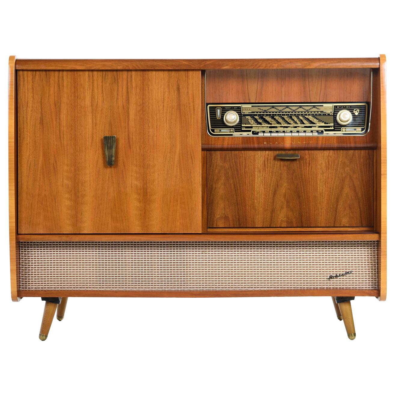 This handsome marvel of German engineering is the Arkansas 59 by Blaupunkt. The Mid-Century Modern HiFi tube stereo features AM/FM and shortwave radio along with a turn table for records. The radio is working but the record player does not work.
