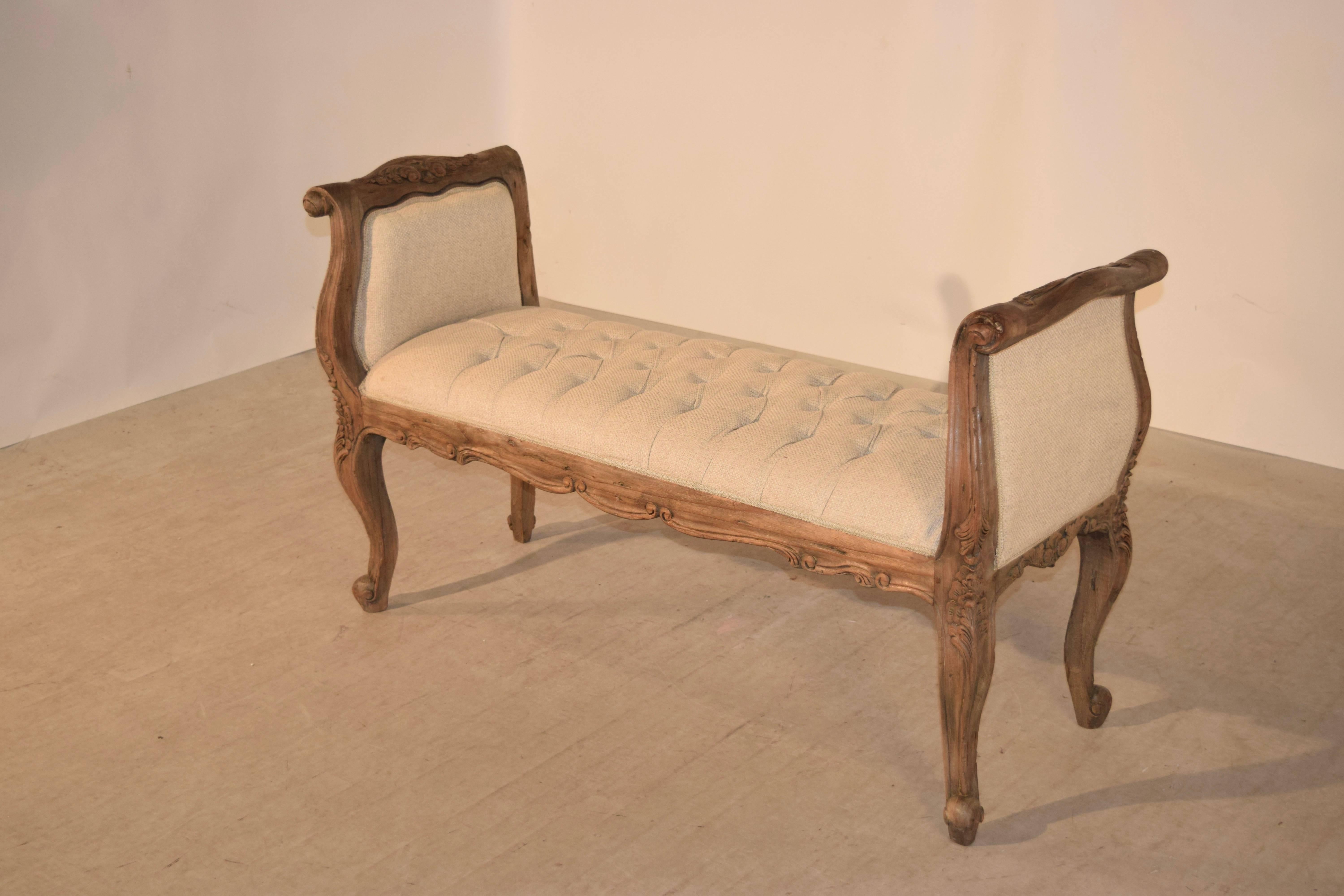 Bleached oak French upholstered bench with a wonderfully hand-carved and shaped frame which has been meticulously upholstered in a chesterfield pattern in linen.
