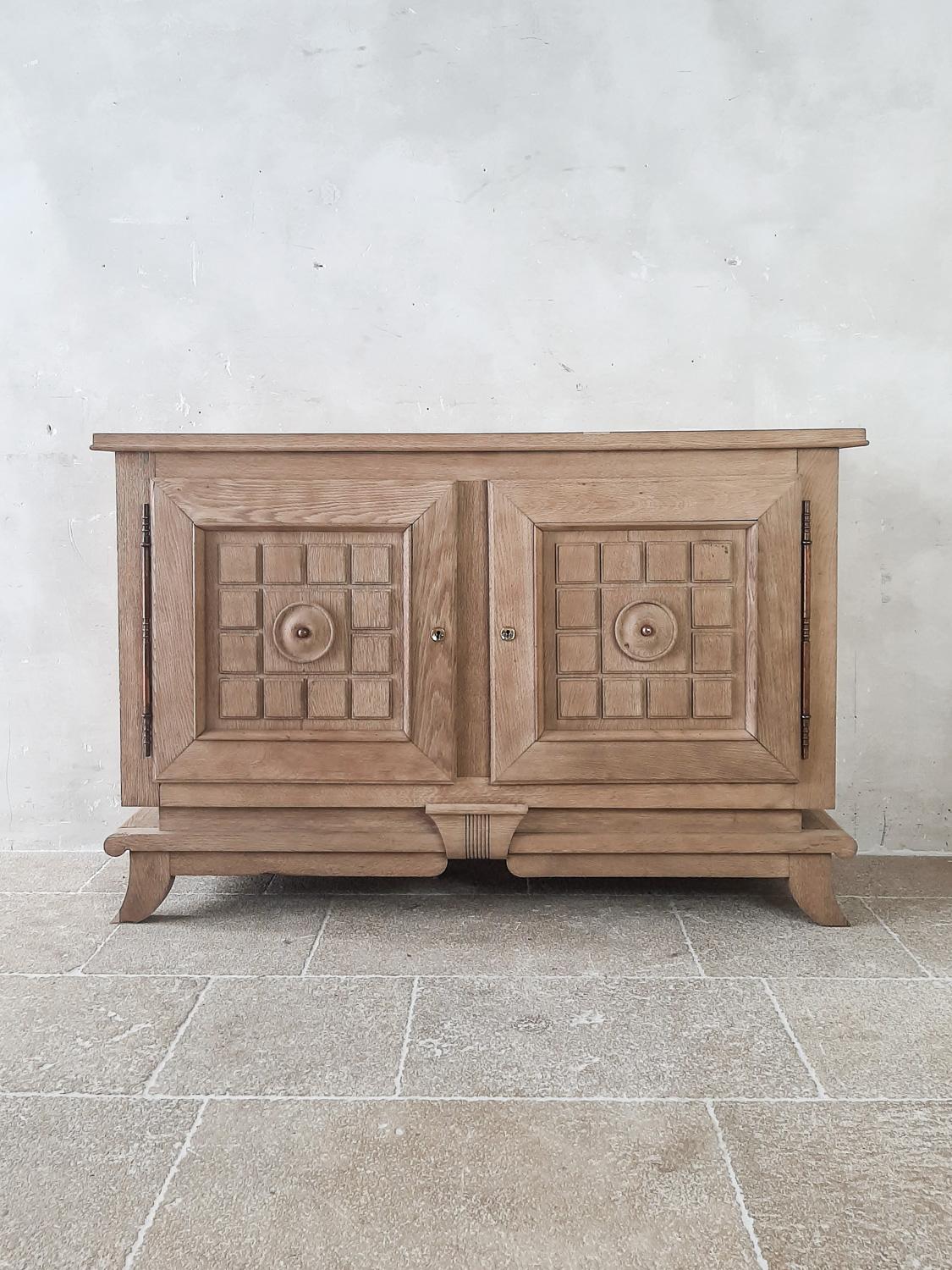 Bleached oak vintage credenza by Charles Dudouyt from the 1940s. Stunning midcentury sideboard with two paneled doors with the typical geometrical shapes of Charles Dudouyt. The top has a wooden chequerboard pattern.

Measures: H 94 x W 146 x D 50