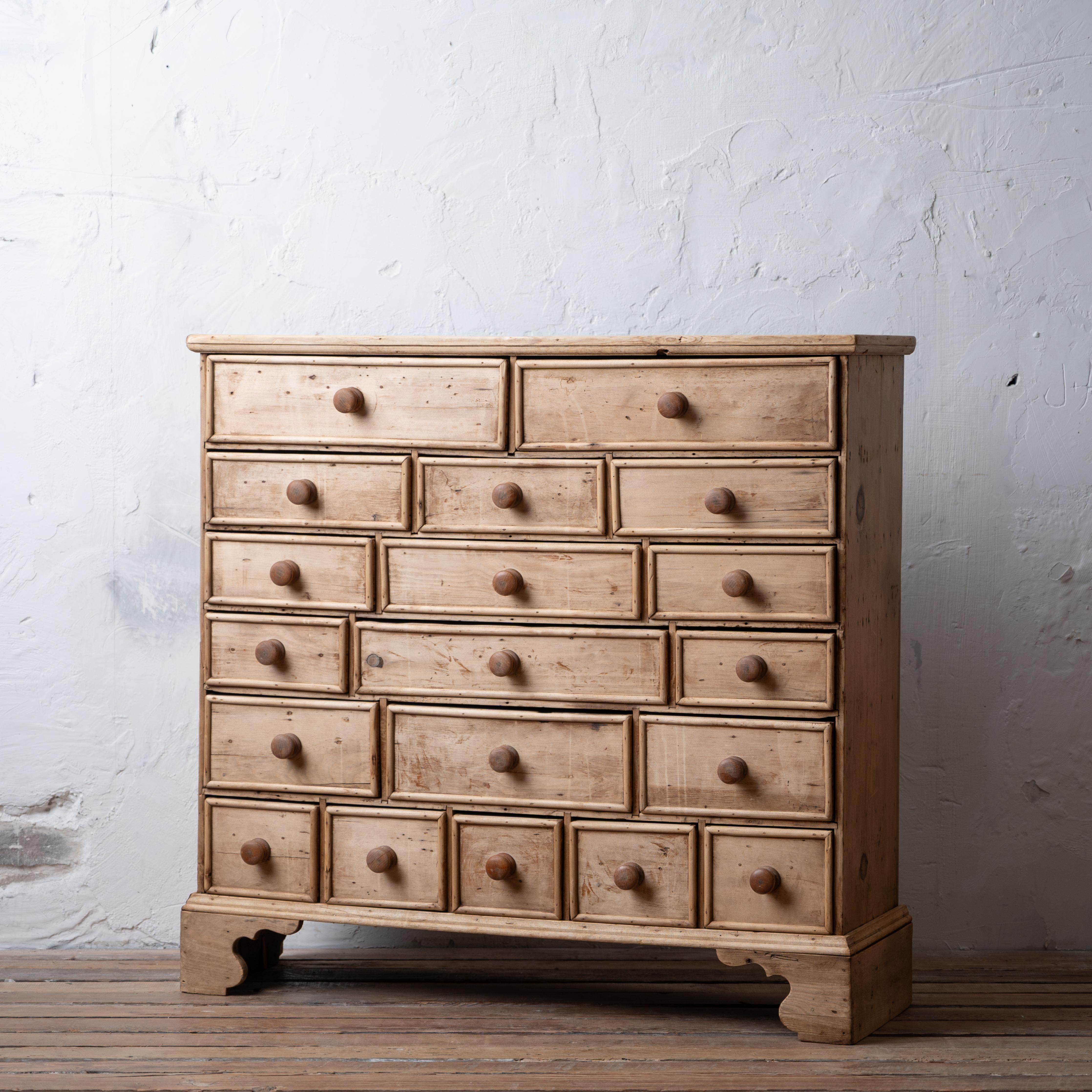 A bleached pine 19 drawer apothecary chest on chippendale bracket feet, 19th century. 

37 ½ inches wide by 12 inches deep by 35 ¾ inches tall

