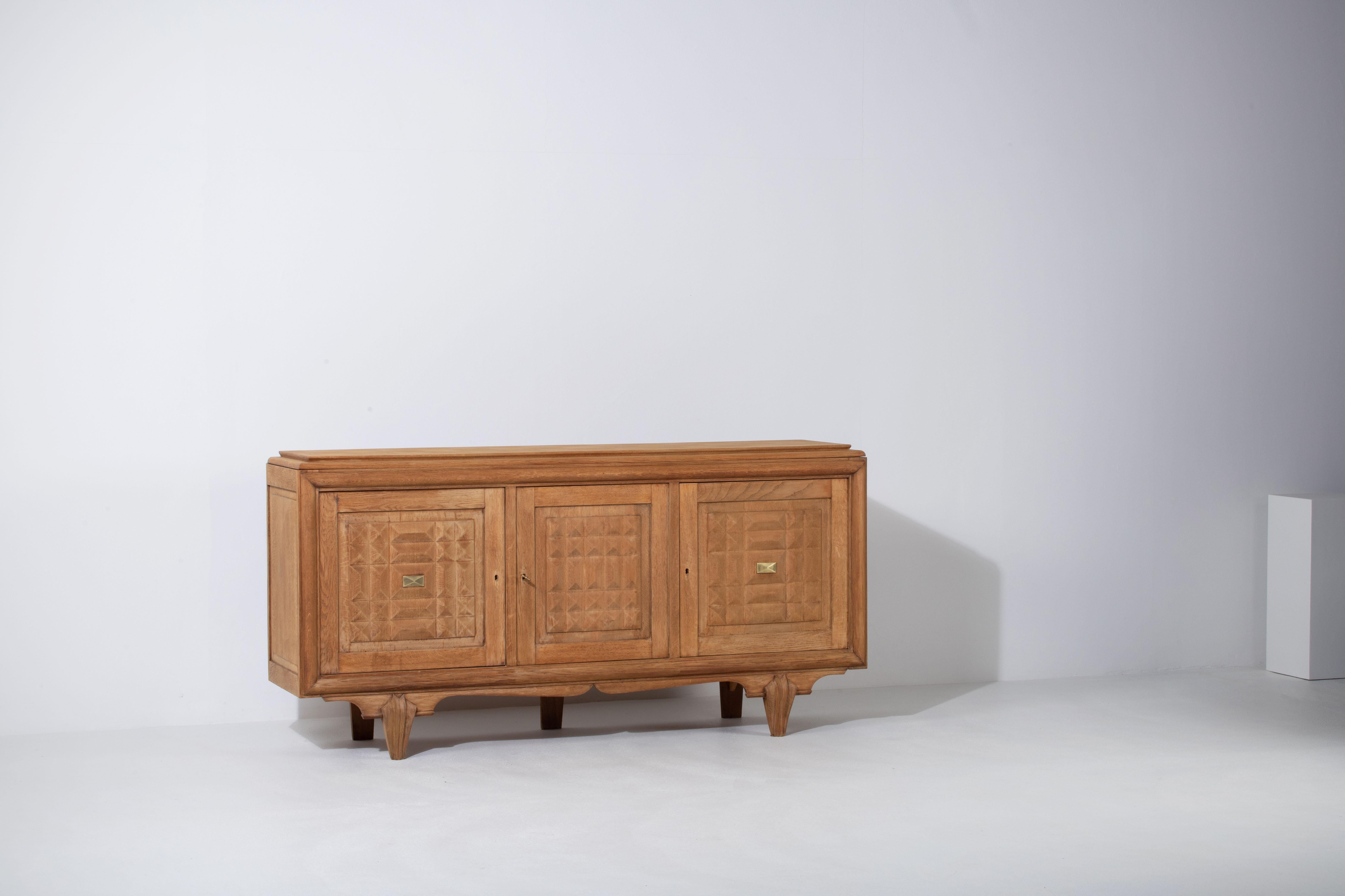 Credenza, solid oak, France, 1940s.
Art Deco Brutalist sideboard. 
The credenza consists of three storage facilities and covered with very detailed designed doors.