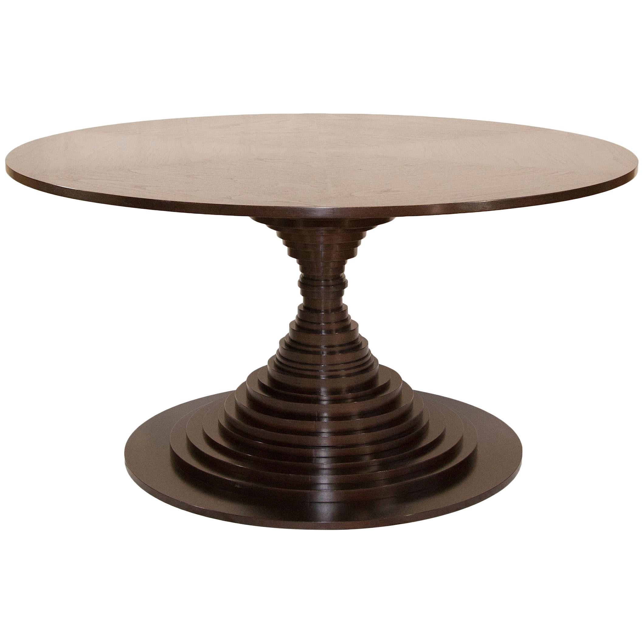 A handcrafted dining or center table. It is artfully composed of 33 individual discs. The impressive top is constructed of multiple sections of walnut or rosewood veneer creating an extraordinary Sunburst pattern. The table is engineered with