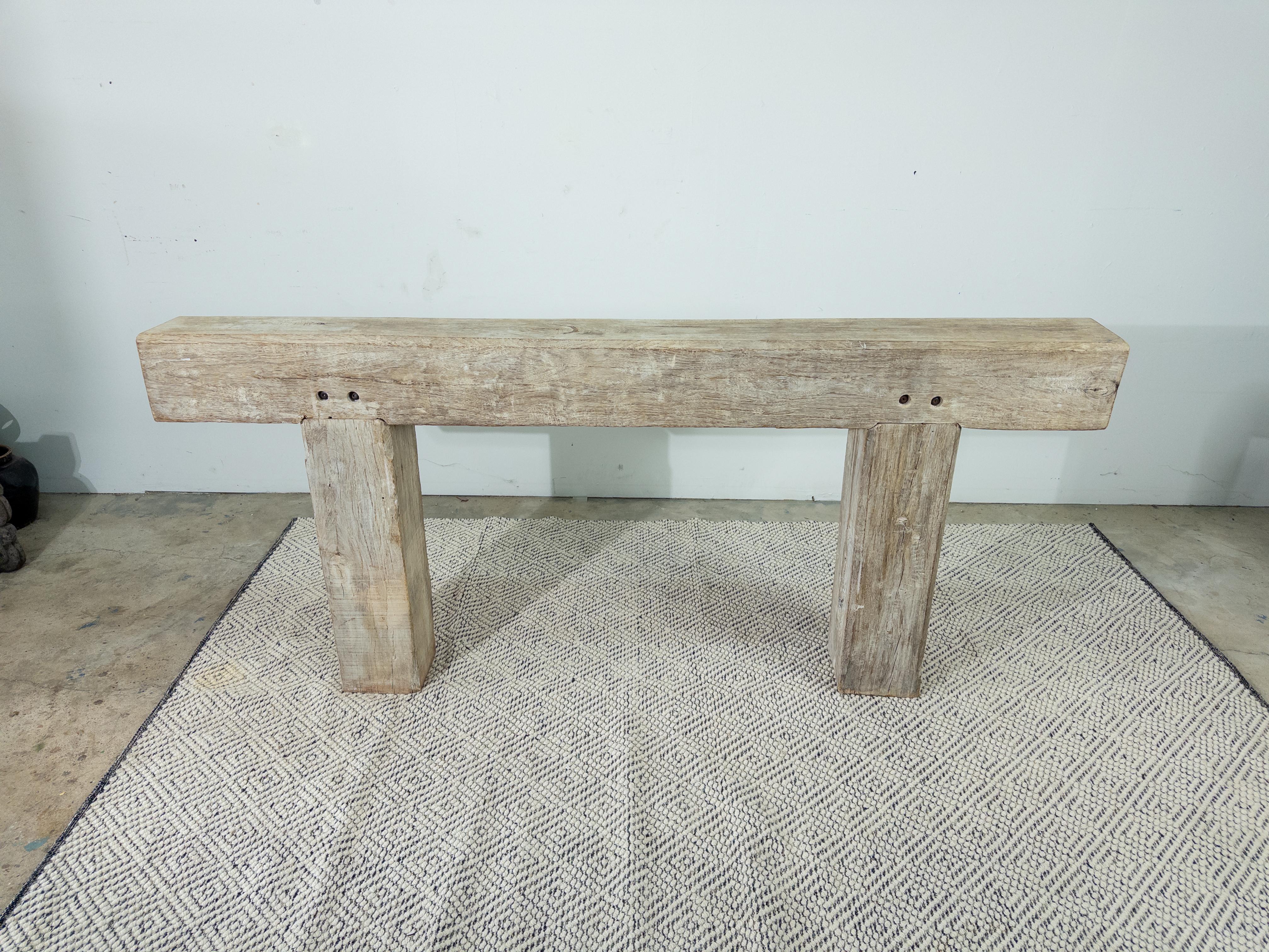 La table console Beam en bois blanchi dégage un charme rustique avec une touche d'élégance moderne. Fabriquée à partir de poutres en bois massif, méticuleusement blanchies pour mettre en valeur les motifs naturels du grain, cette table console