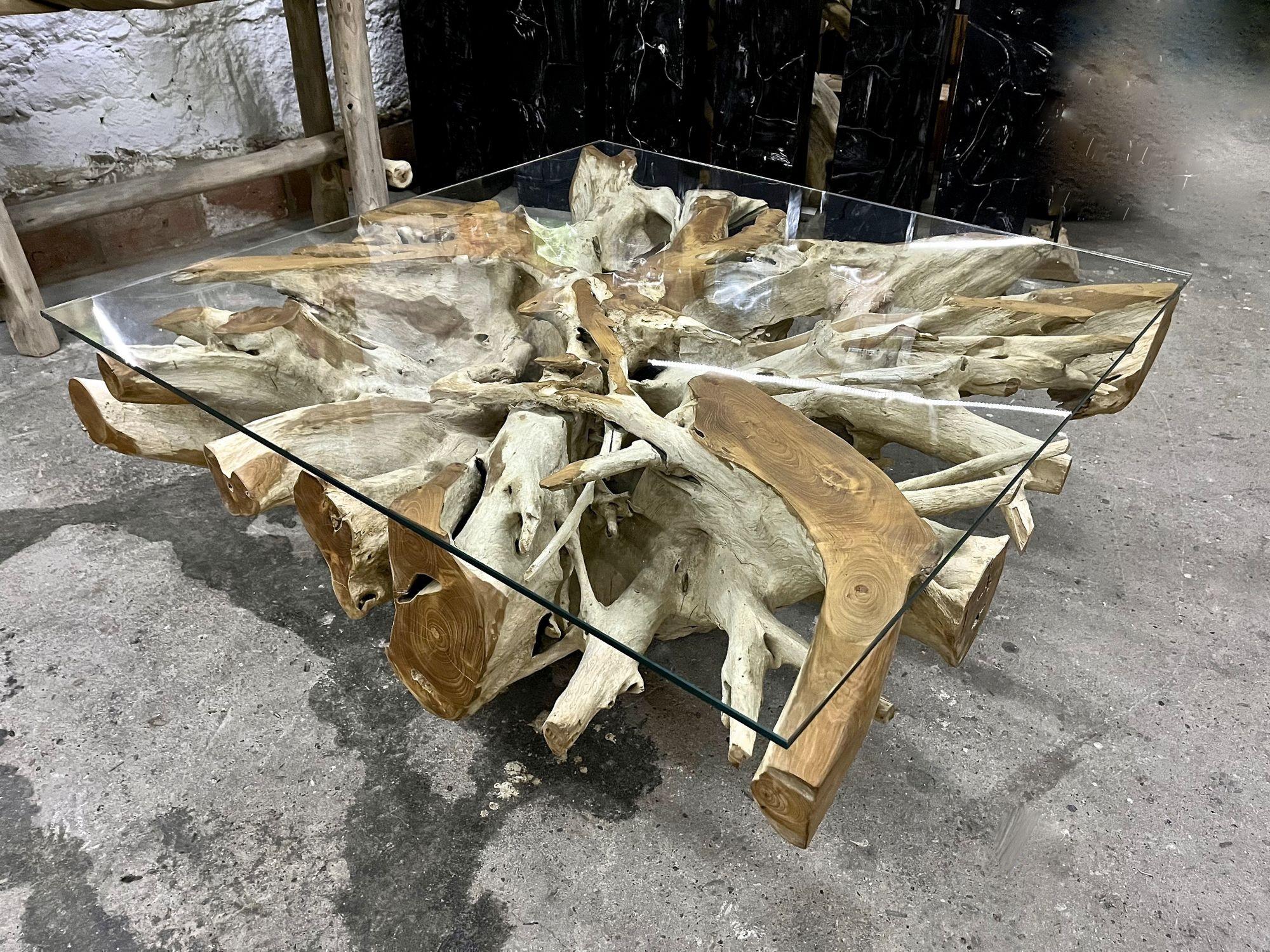 One of a kind, large organic modern teak root table from Indonesia. This unique, square shaped coffee/ cocktail table impresses with a large teak root which has been artfully cutted out from a very huge root, carefully chosen by the artist herself -
