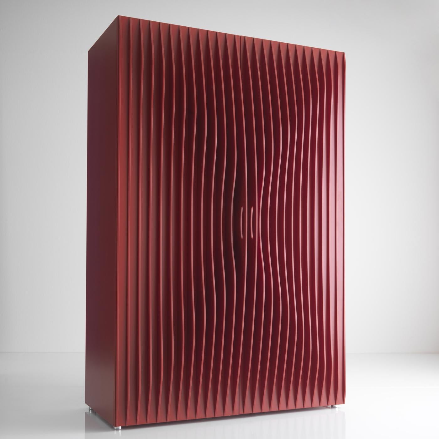 A sculptural piece of functional decor, this wardrobe boasts the dynamism and elegance typical of Karim Rashid's design. Frame, shelves, and doors are made of red-lacquered MDF, boasting a stunning ripple-effect. The interior is illuminated by LED