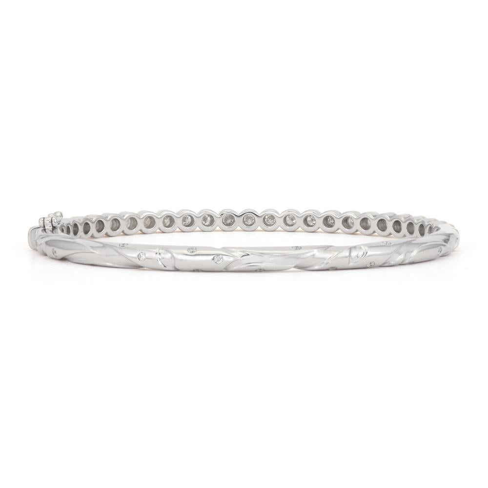 Classic with a twist. Blended with 14K yellow gold and sterling silver, the Blended Stories Blended Hammered Diamond Bezel Bangle features sparkling round diamonds with hammered bezels and a unique engraved vine detail so no matter how you wear it,