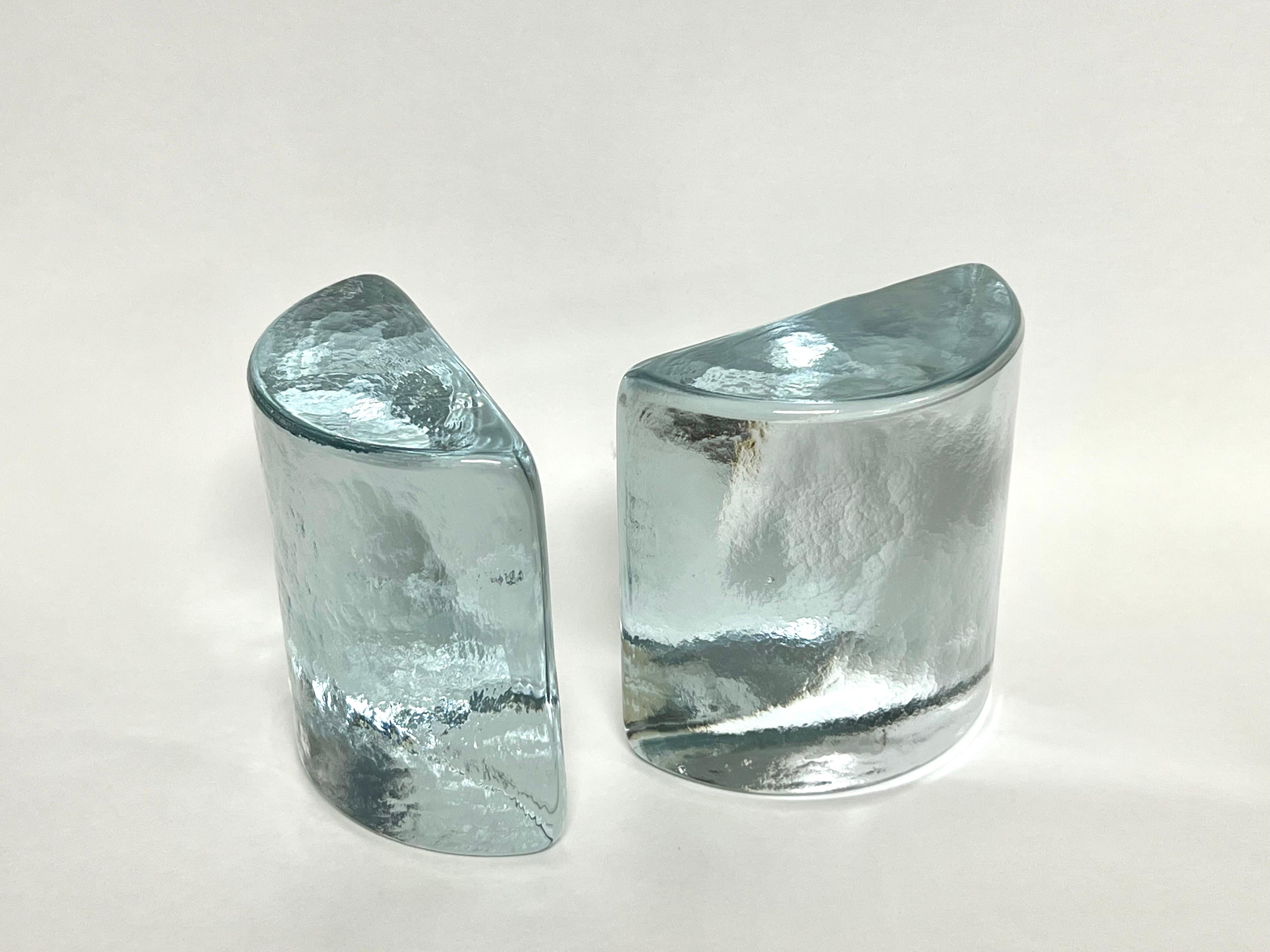 A pair of glass bookends by Blenko. Solid glass with a subtle texture on the surfaces. 
Retain manufacturer sticker.