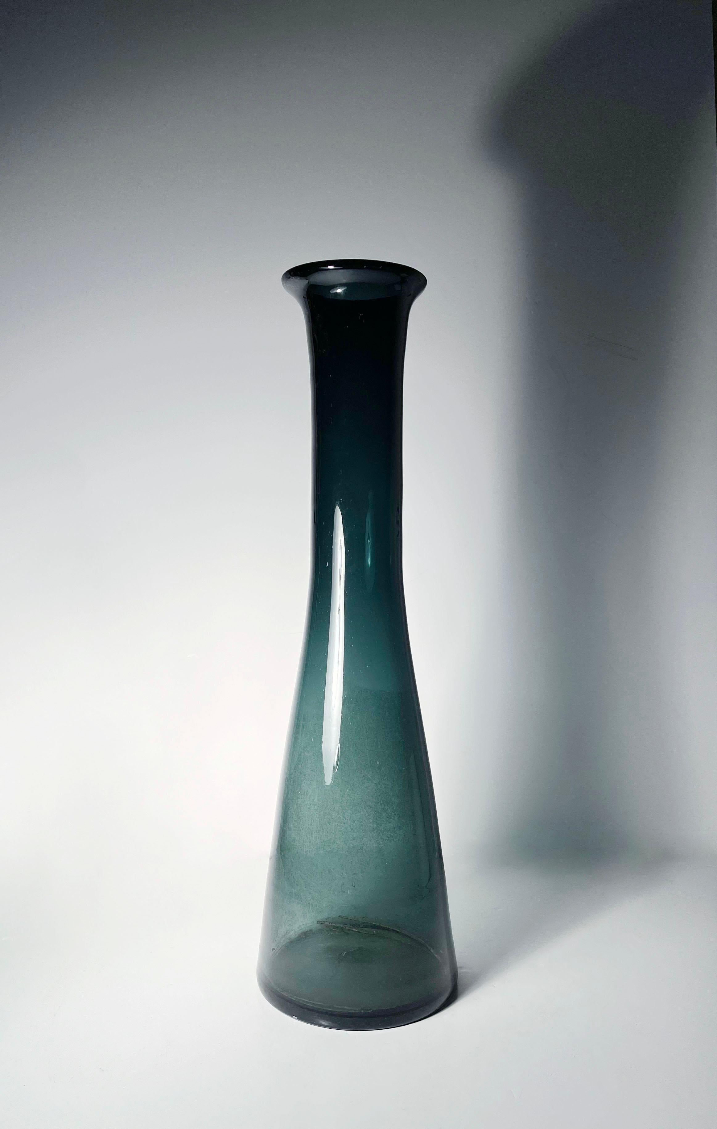 Blenko Architectural Glass Vase Model 5415 by Wayne Husted

The neck seems to slant slightly depending on angle of viewing. Showing 2 points of view in photos. Can also be seen in the catalog photo. These were handblown vases.

Have not cleaned the