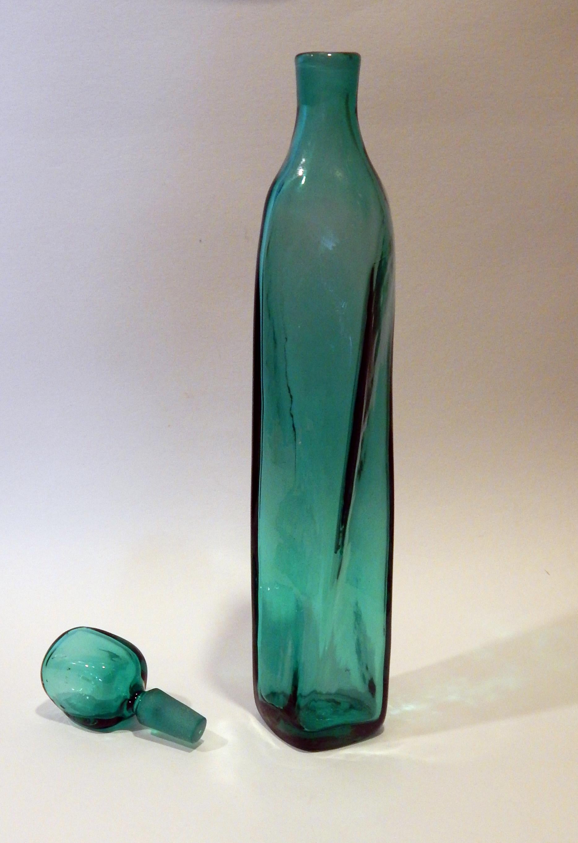 Blenko twist decanter with stopper by Wayne Husted in Seagreen. #58255.
Measures: 18 ½