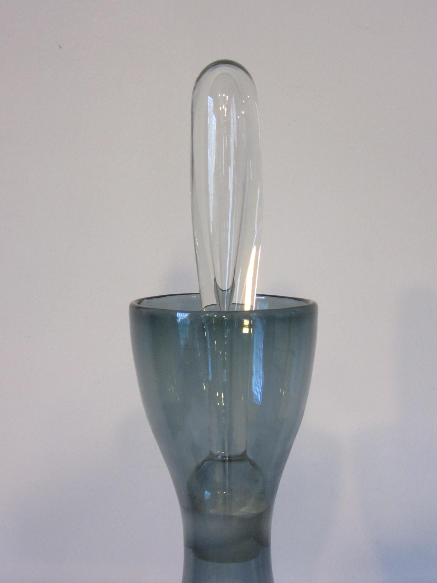 A smoked hand blown glass decanter vase with clear tear drop stopper crafted by midcentury master glass blower Wayne Husted for the Blenko Glass Company, a wonderful object.