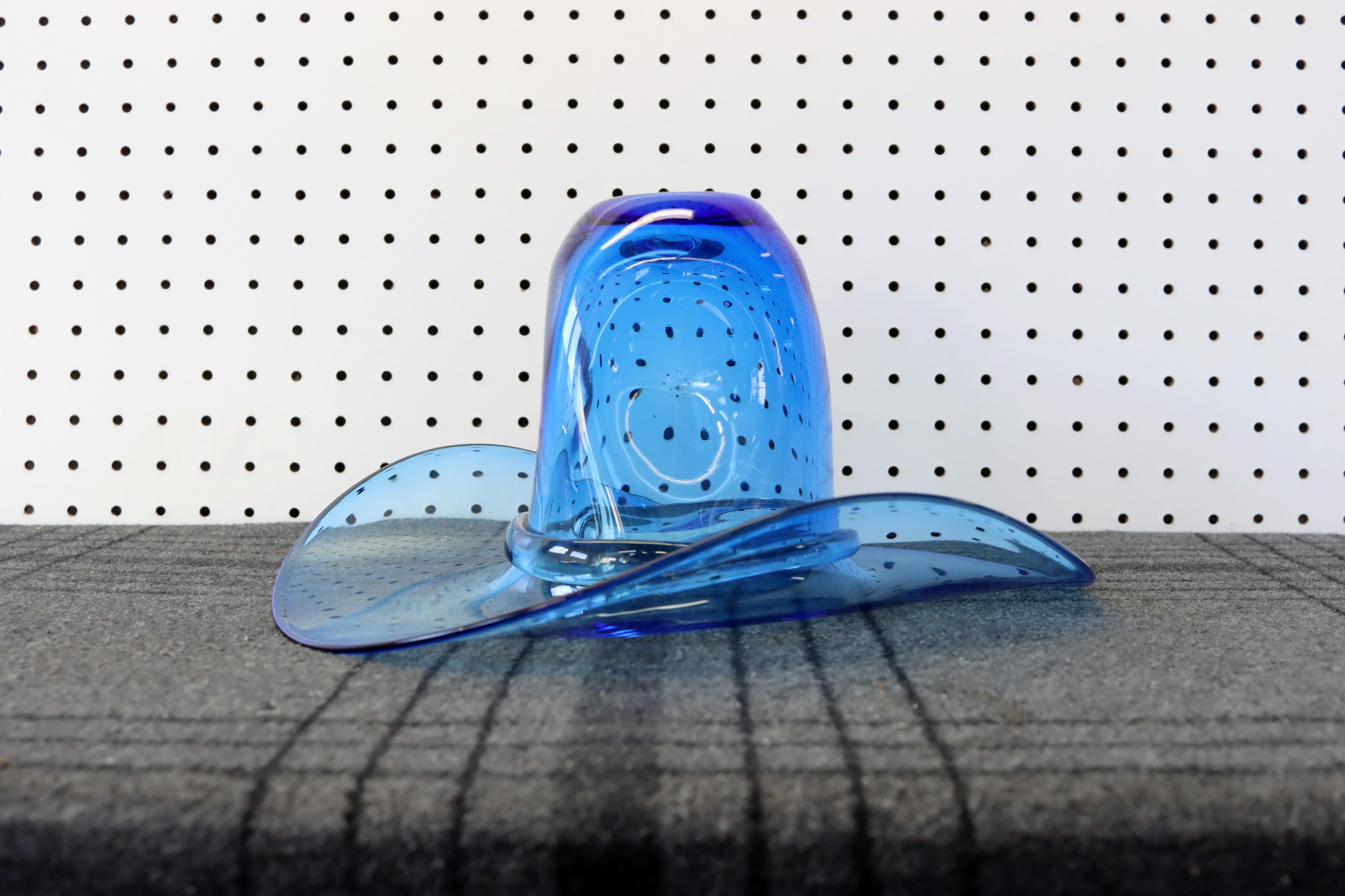 A scarcely seen blue Blenko Glass cowboy hat. Use it as a vase, ice bucket, or art glass sculpture. Heck, you could even wear it for a night out on the town.

In great vintage condition with no chips, scratches, or cracks.

Measures 11” wide x