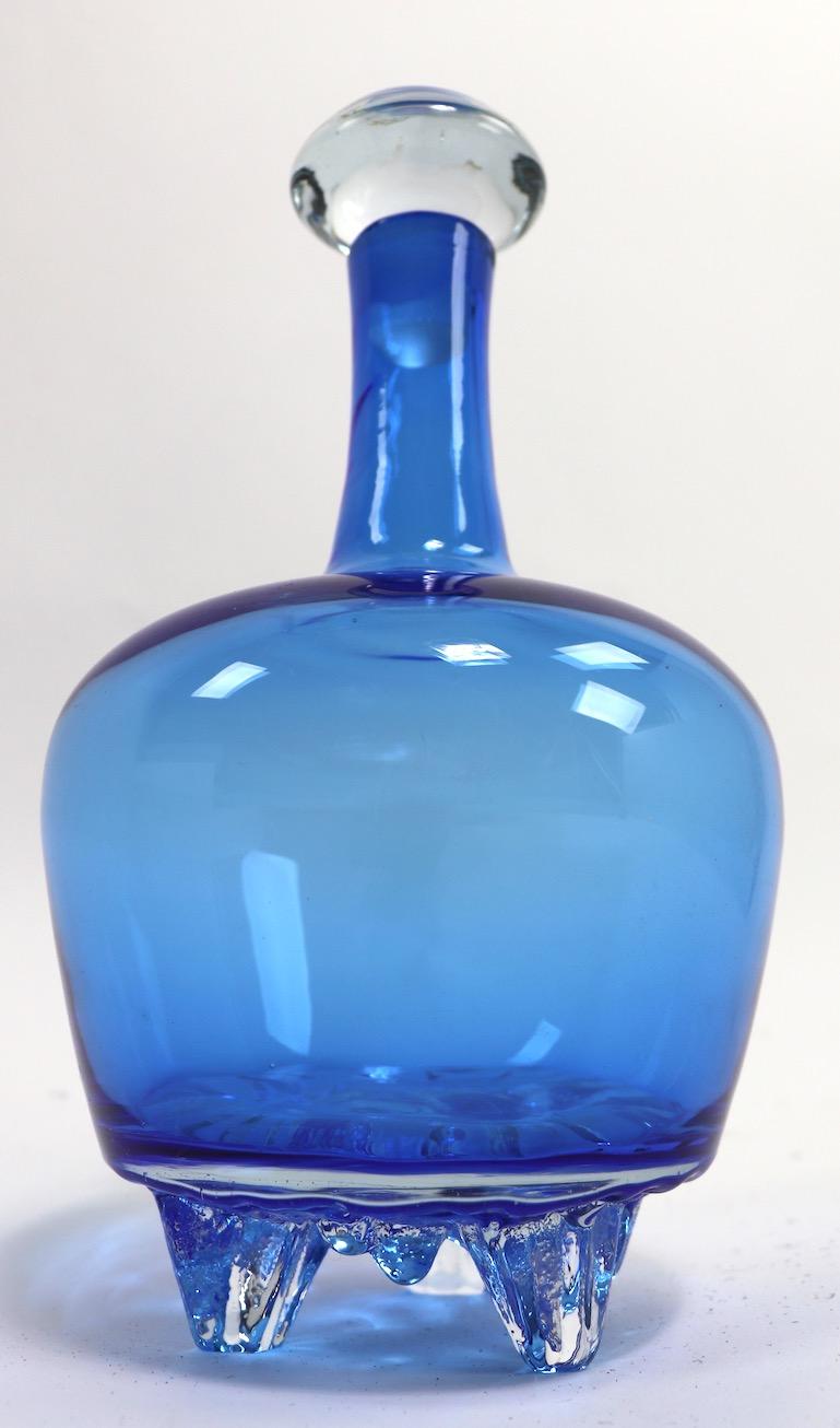 Rare Blenko stoppered decanter bottle by Wayne Husted (signed). This interesting bottle has stylized icicles at the base. No damage or condition issues.