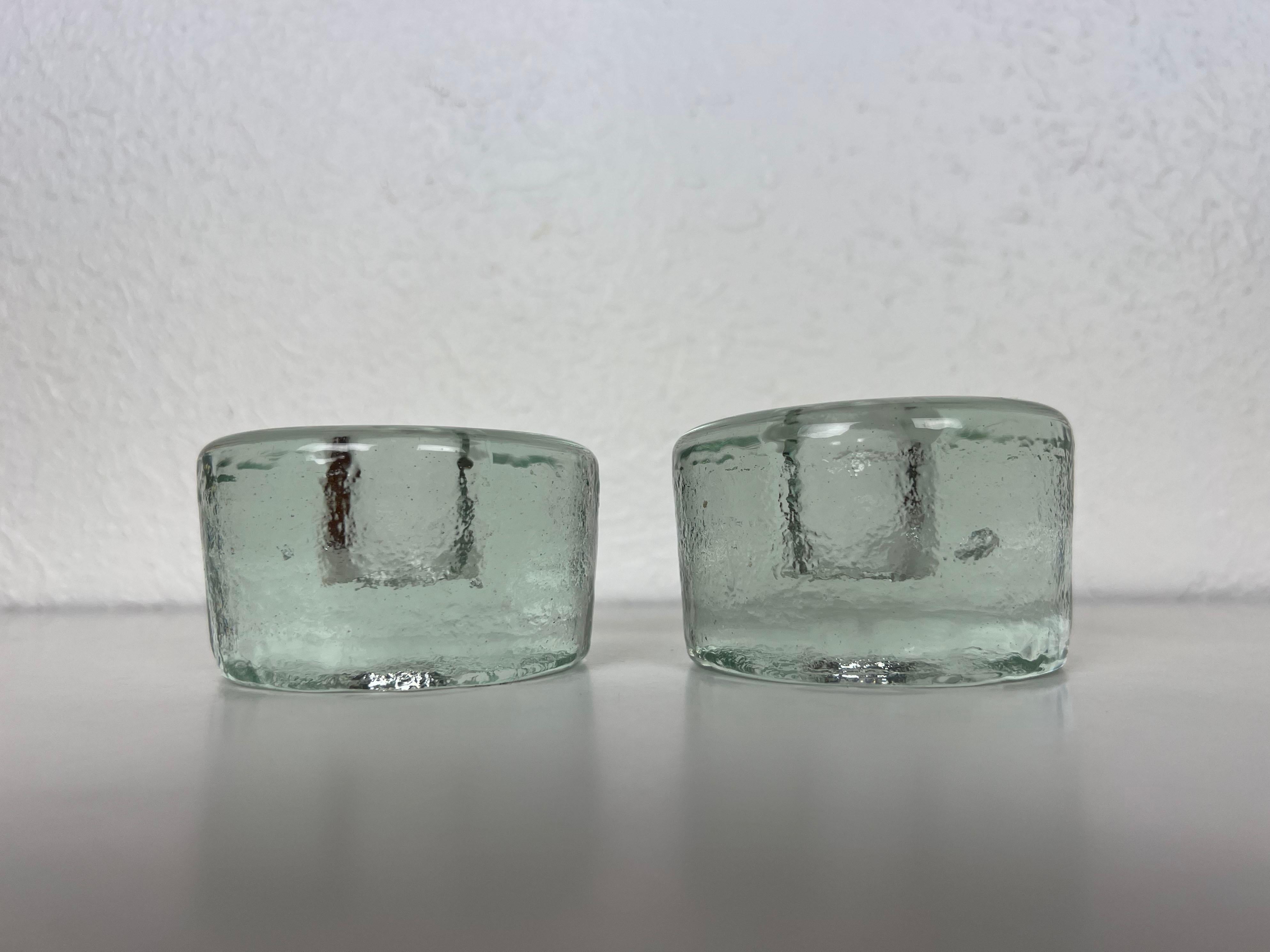 Vintage pair of puck shaped glass candleholders by Blenko. Handmade from solid glass, slightly different in size.

Manufacurer: Blenko

Origin: USA

Year: 1960s

Syle: Mid-Century Modern

Dimensions: 3.25