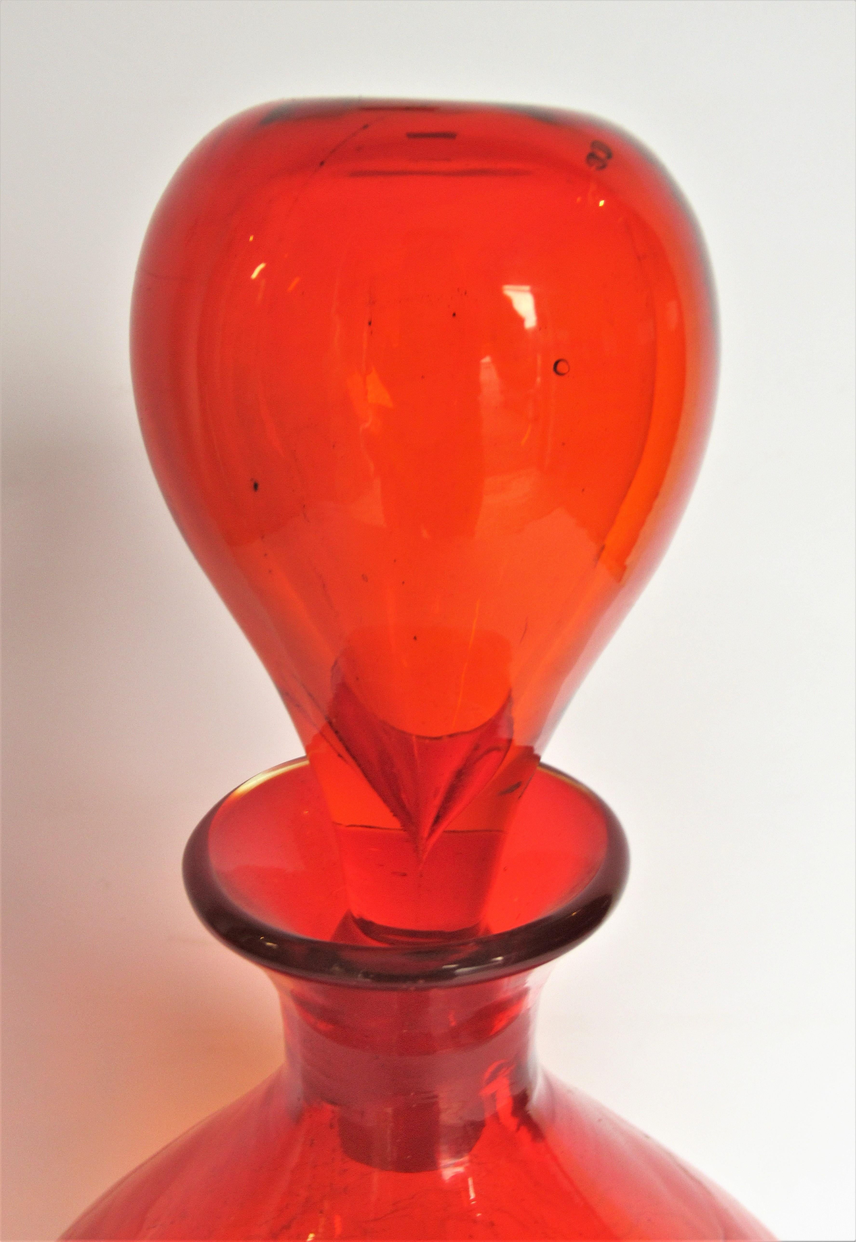 Large bulbous brilliant deep tangerine orange crackle glass decanter bottle by Wayne Husted for Blenko, circa 1960. Bottle with stopper is 13 inches high x 8 inches widest point. Bottle without stopper is 10 1/2 inches high. Look at all pictures and