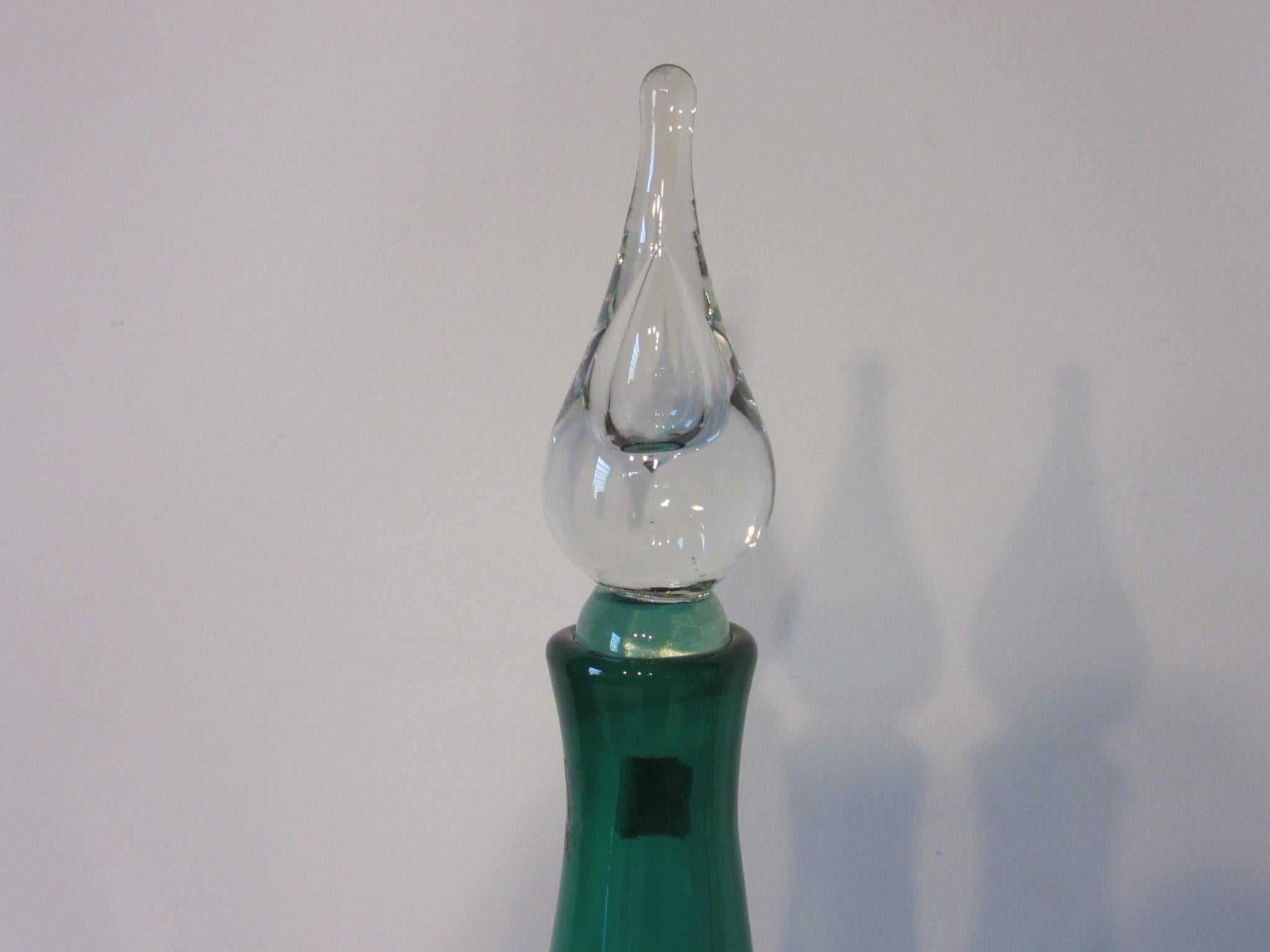 A green bodied hand blown glass vase with clear tear drop stopper retains the original Blenko tag and to the bottom etched signature signed and dated Richard Blenko 2003.