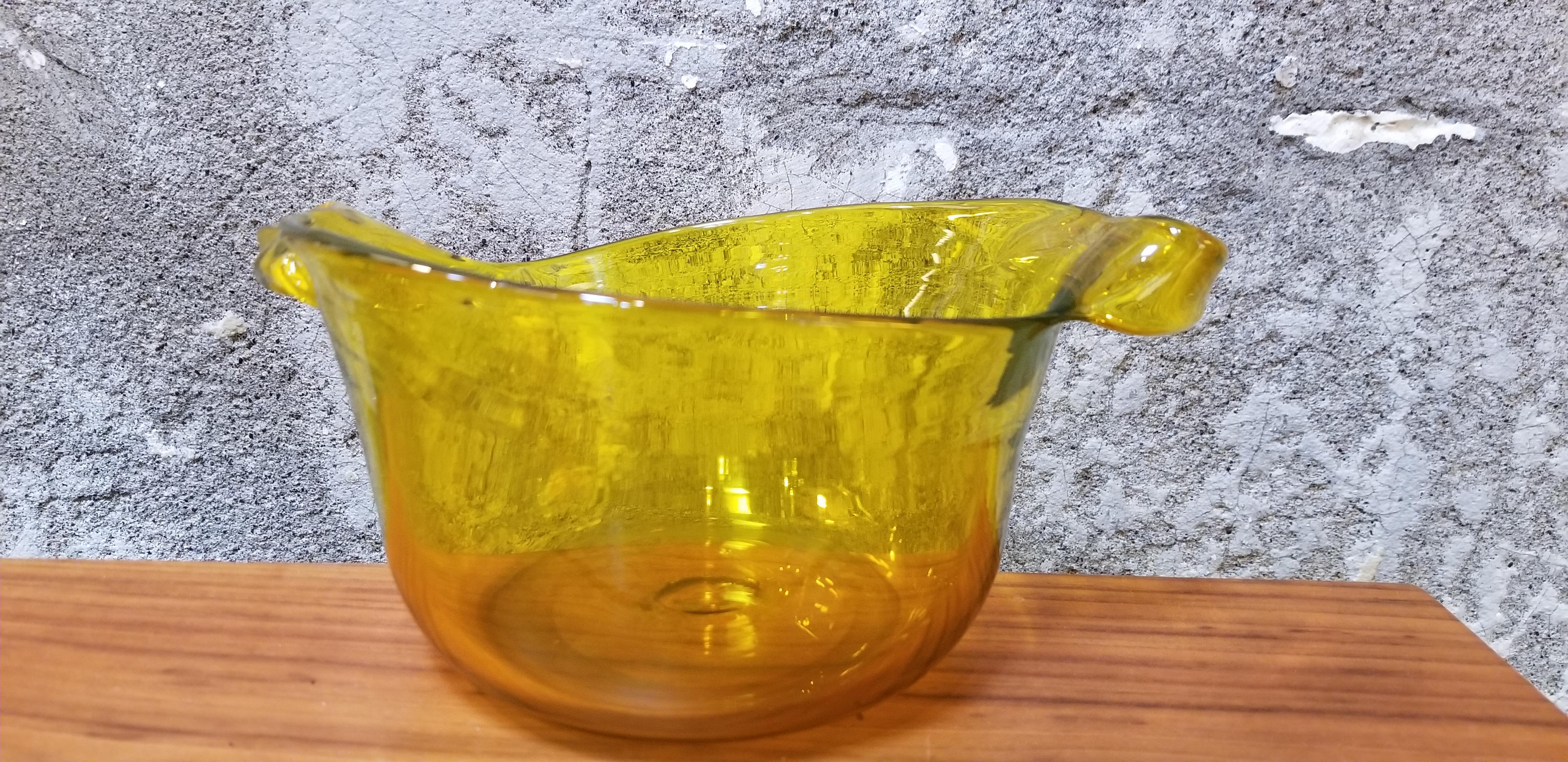 Hand crafted asymmetrical citrine art glass handled bowl. Signed on base 