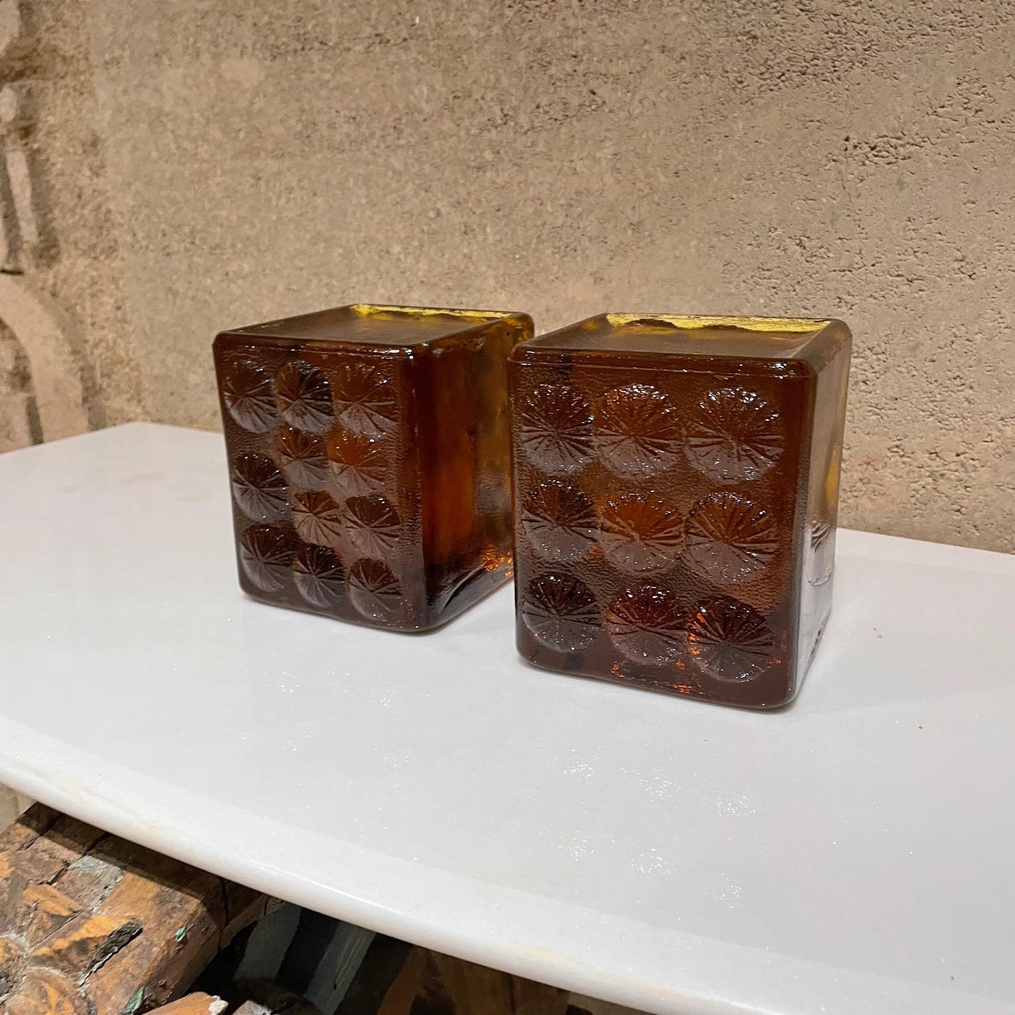 Glass Bookends
By Blenko abstract ice glass block sculpture modern bookends in amber glass 1967
By designer Joel Myers for Blenko Glass of West Virginia
Heavy pair of square amber colored pressed glass bookends with textured abstract flower