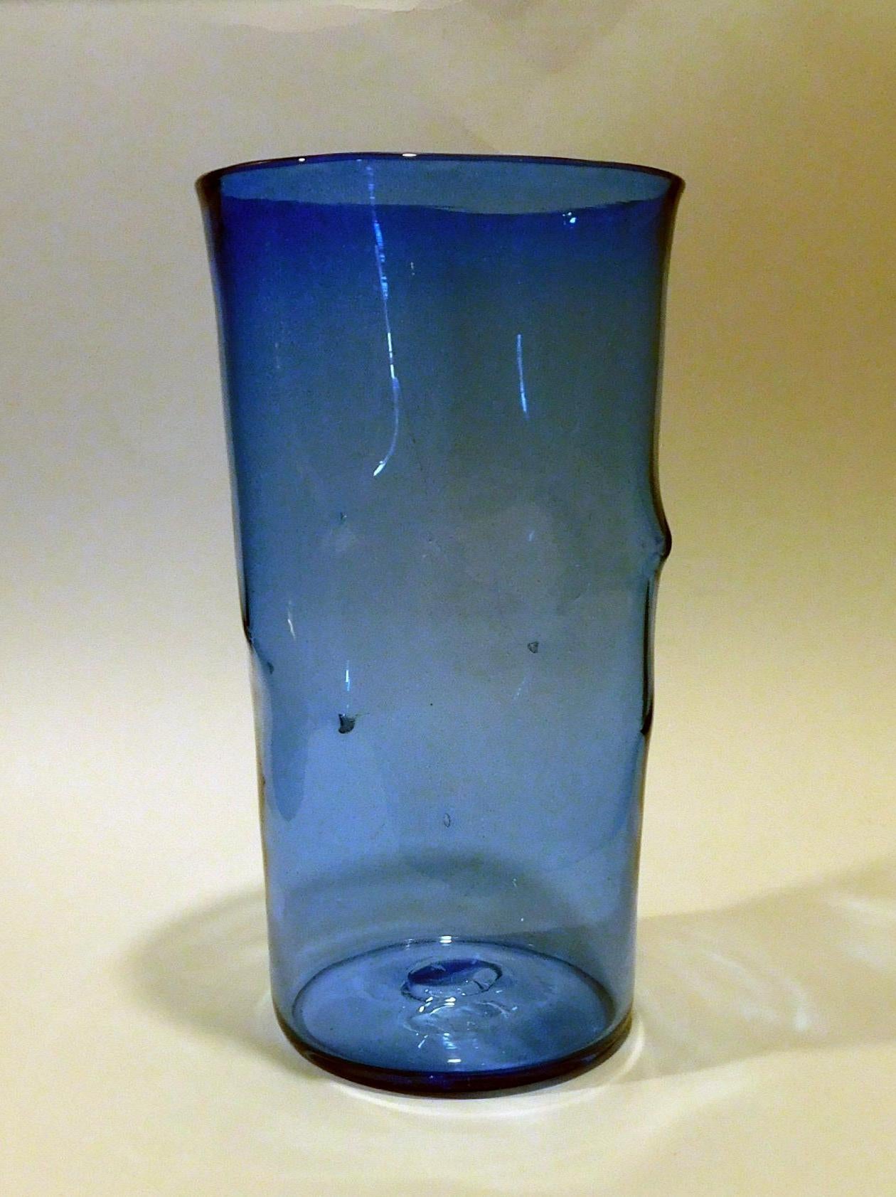 Beautiful blue tall cylindrical pinched vase with Blenko acid etched signature.
Measures 12 ½ inches tall. The angular top measures 6 3/4