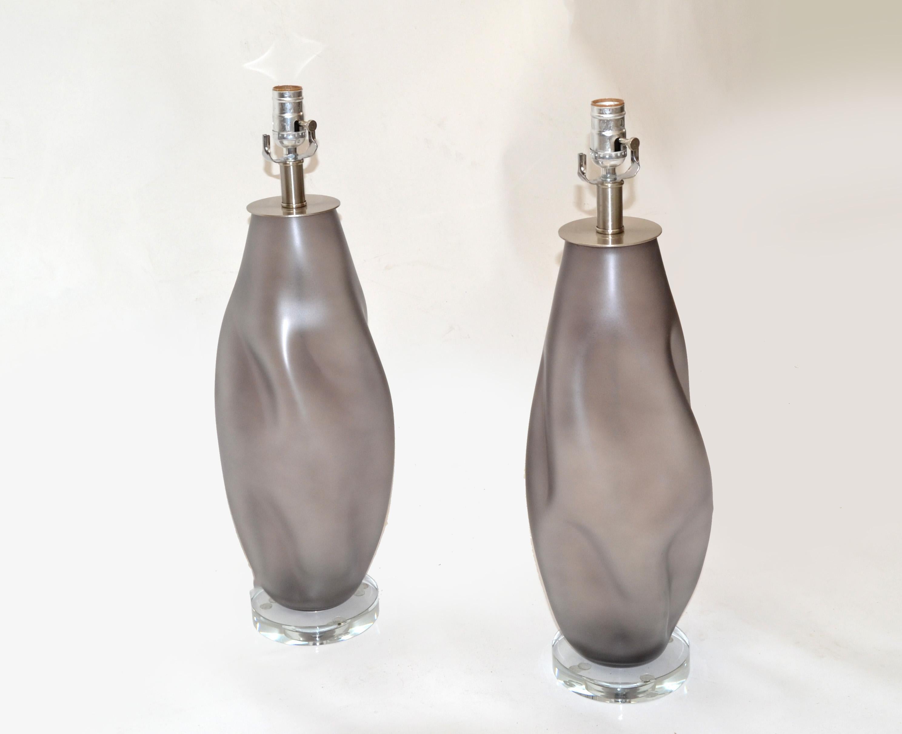 Pair of Blenko Mid-Century Modern frosted light gray blown art glass table lamps with Nickel Hardware.
The lamps have an acrylic base and Nickel Sockets.
US Rewiring, UL Listed, in perfect working condition and each uses a max. 60 watts light bulb