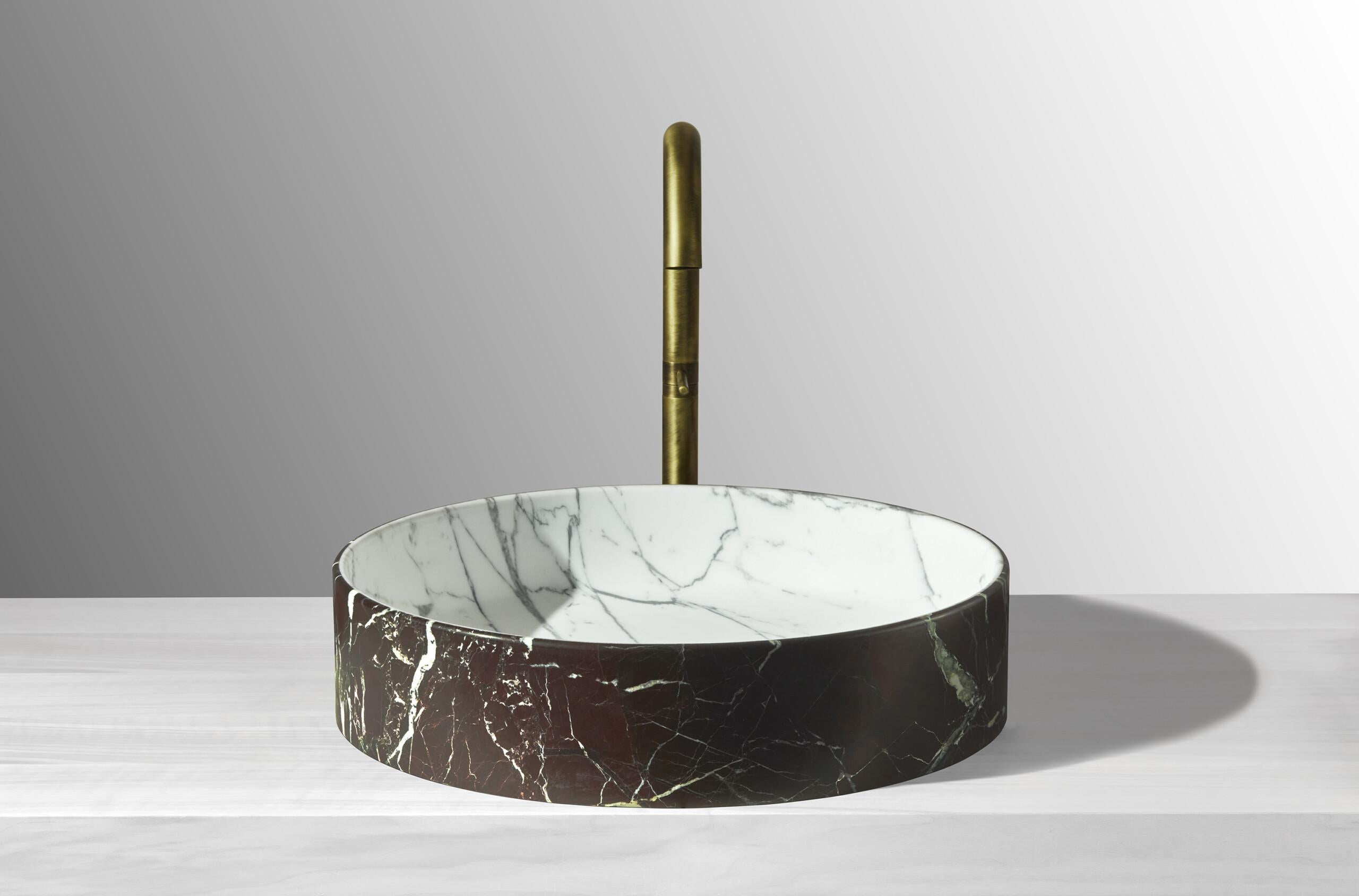 Blessed Circle Countertop Basin by Kreoo 
Designed by Christophe Pillet
Dimensions: Ø 50 x H 12.
Materials: Rosso Lepanto and Calacatta Carrara marbles.
Weight: 18 kg.

Available in different marble and travertine options. Prices include a drain
