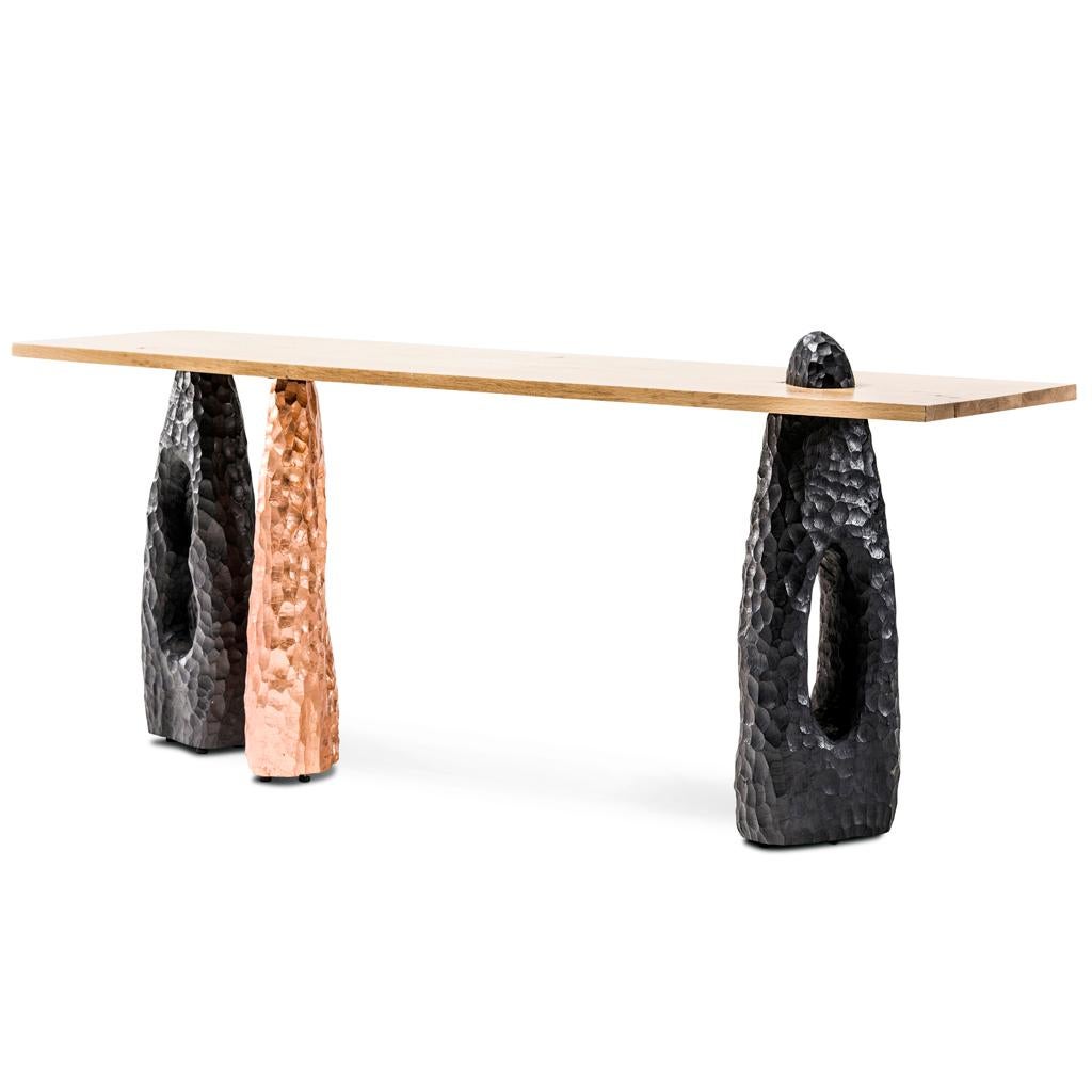 The Modern Primal Console is part of the Blessing collection designed and manufactured by Egg Designs in South Africa.
The Blessing console has three legs that are hand chiseled using Alien timbers. Two legs are treated with a burnished black