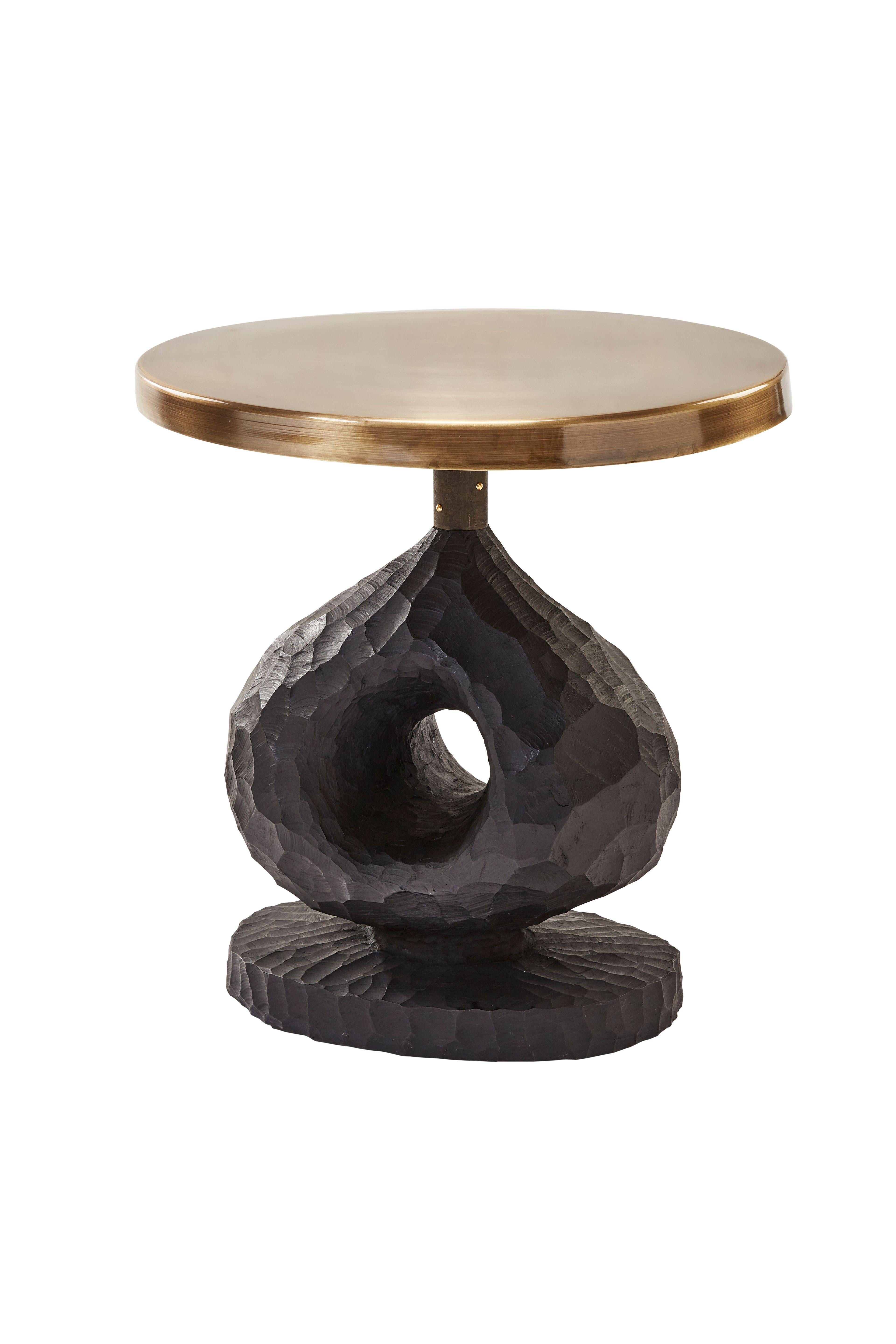 Blessing Side Table by Egg Designs
Dimensions: 60 L X 60 D X 65 H cm 
Materials: Chiseled Alien Wood, Bronze Coated Steel

Founded by South Africans and life partners, Greg and Roche Dry - Egg is a unique perspective in contemporary furniture
