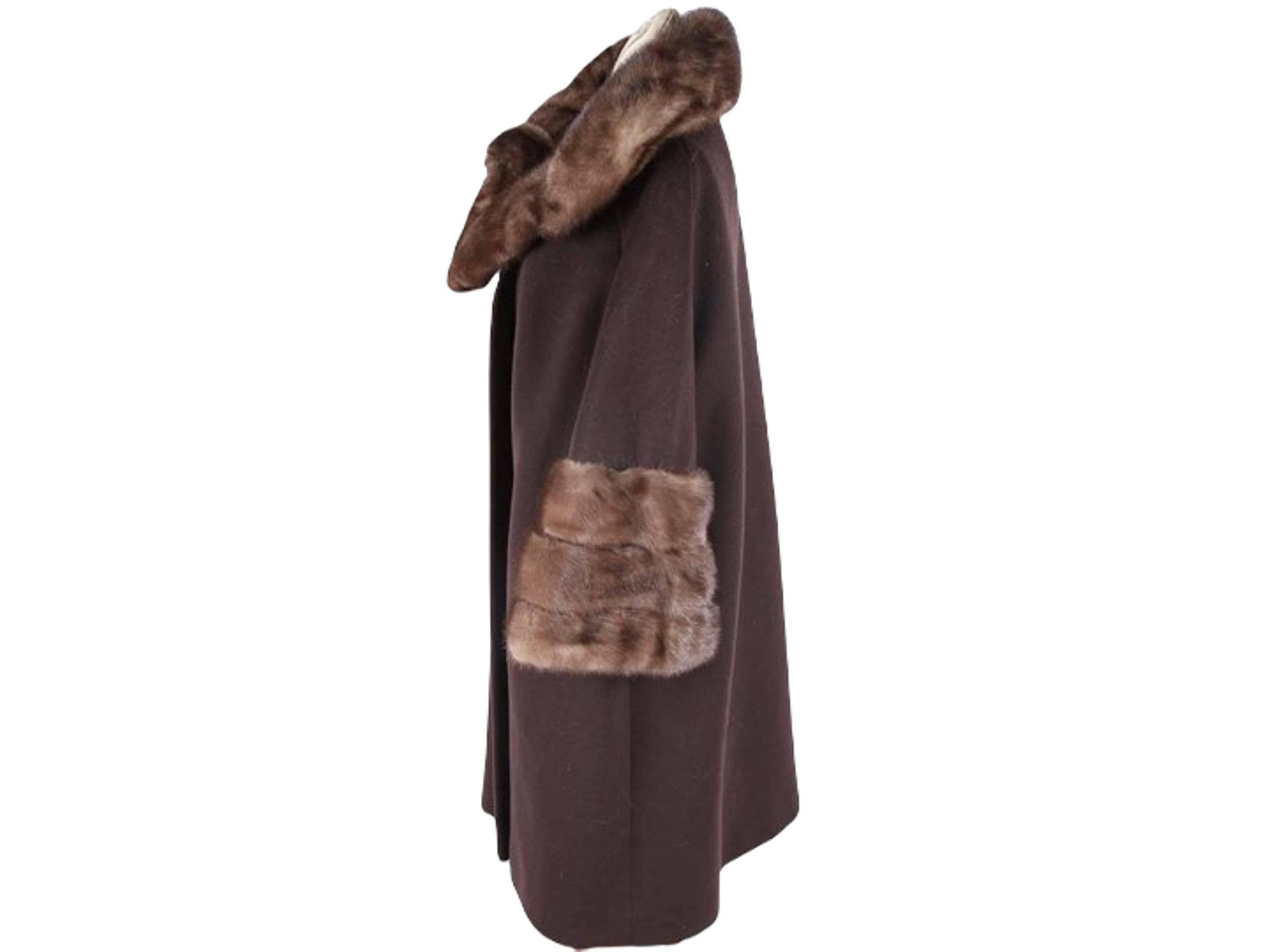 This coat is simply amazing - an exquisite Blin + Blin custom couture wool and mink fur coat circa the 1950s. The luxurious mink fur accents and highest quality tailoring make this piece a truly elegant choice for the colder months. The coat is
