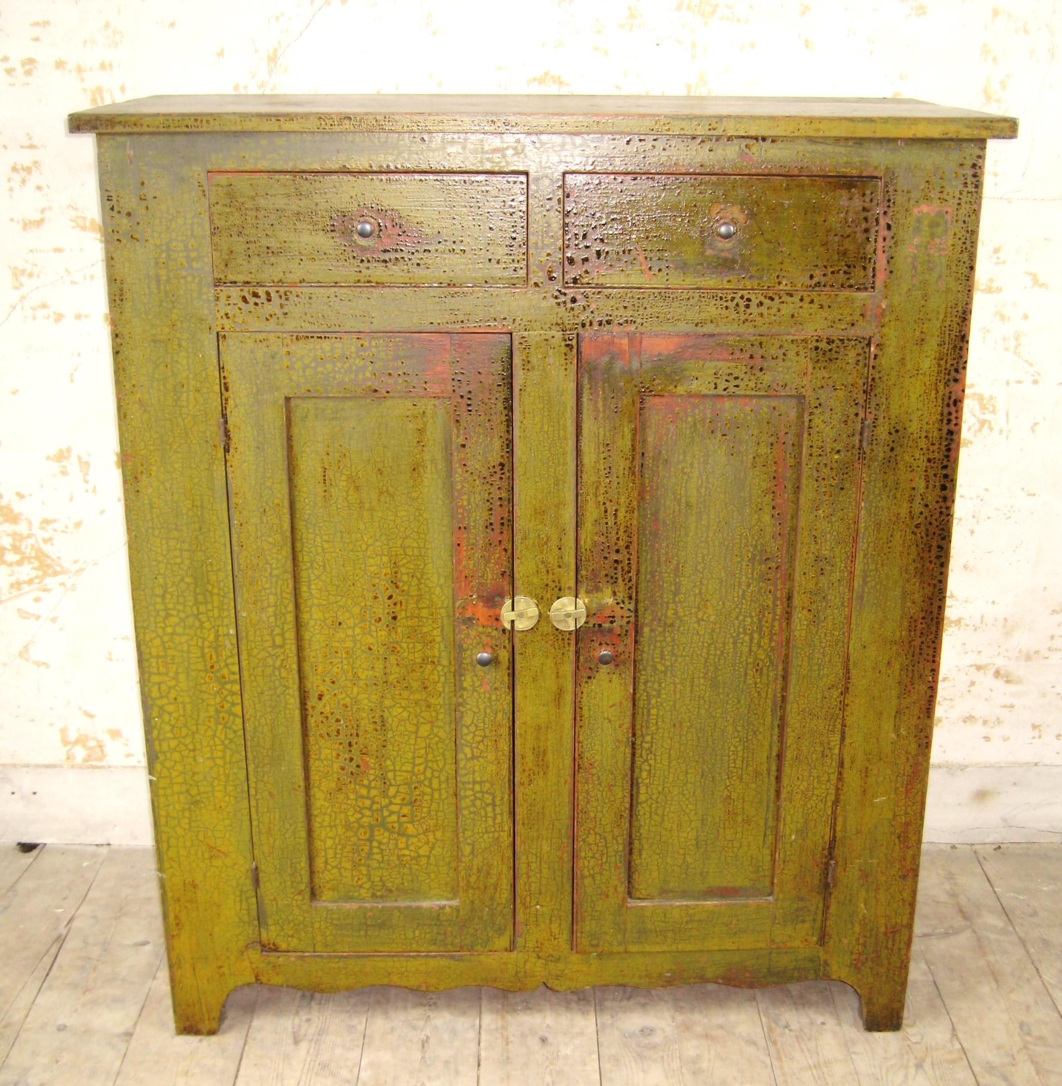 Fabulous Blind door 2 draw green painted 1860s cupboard, it has many layers of paint which are worn through in many spots to reveal the original red wash. I have owned this piece in my personal collection for over 25 years. Please look at all the