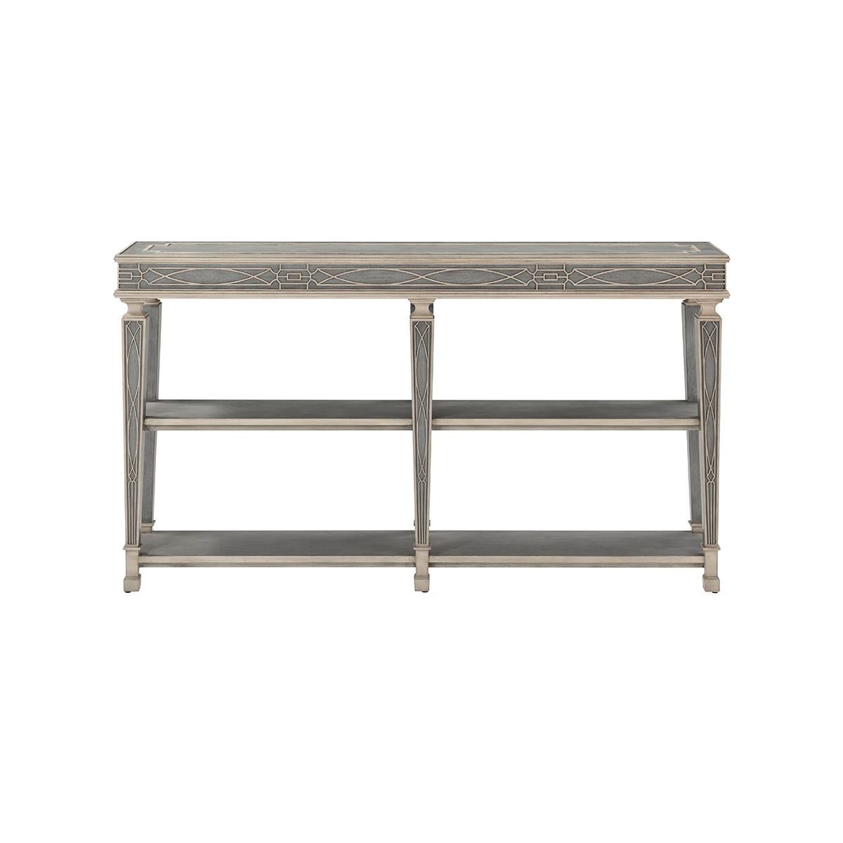 A grey limestone finished console table with fretwork and accented with a molded carving apron and two hidden drawers on each side. Raised on six tapered legs with detailed carved molding, the console table is joined together with two under-tier