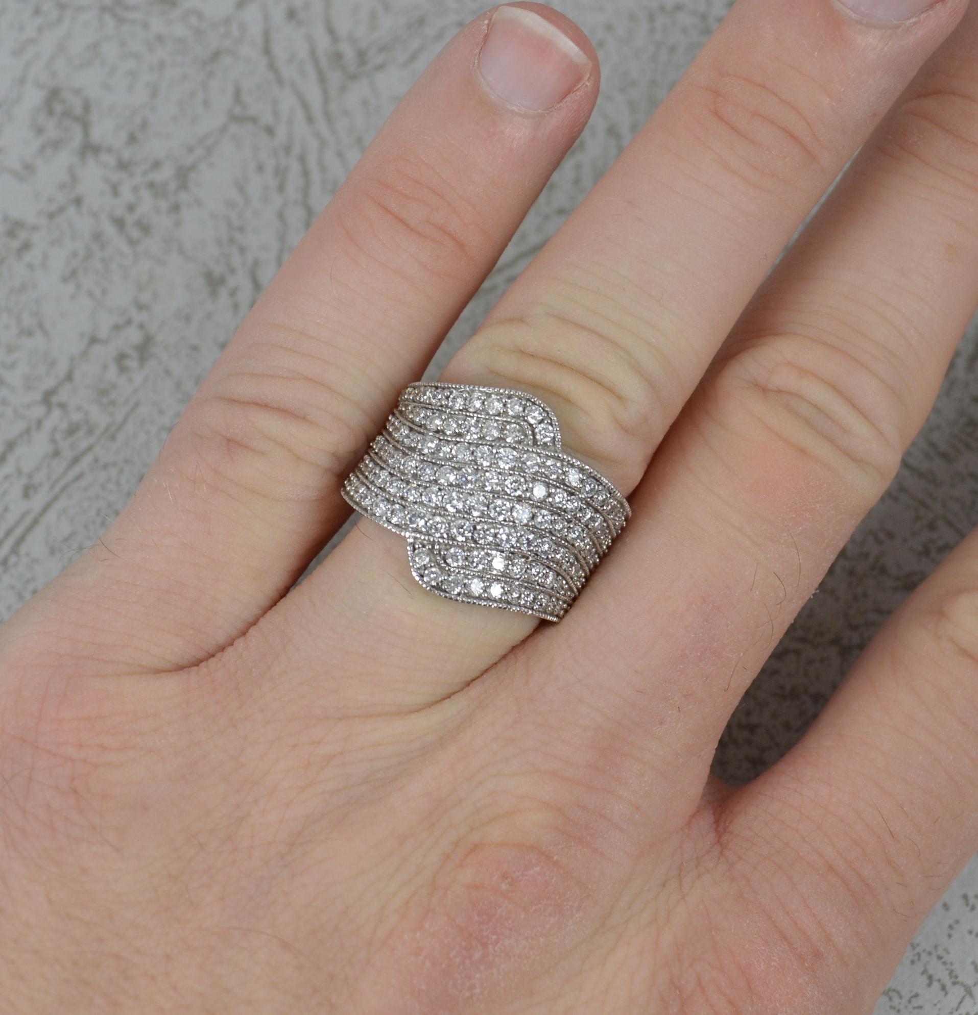 A large natural diamond cluster cocktail ring.
Solid 18 carat white gold example.
Set with many natural round brilliant cut diamonds to total 1.50 carats as confirmed to the shank. Si clarity, very clean and sparkly.
17mm x 22mm cluster.

CONDITION