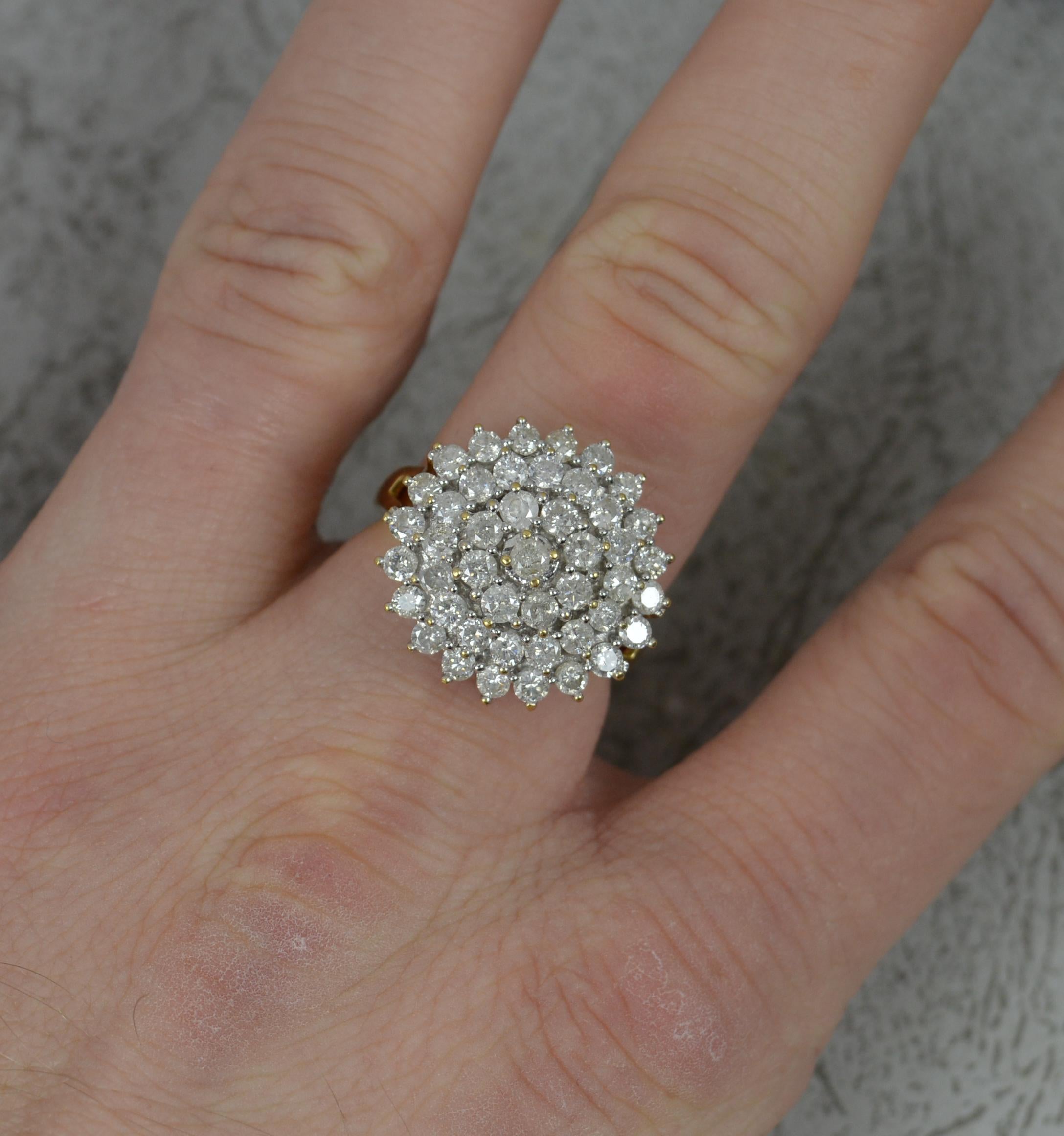 A large natural diamond cluster ring.
Solid 18 carat yellow gold shank and white gold head setting..
Designed with many round brilliant cut natural diamonds, a four tier cluster head.
18mm x 18mm cluster head. 
2 carats of natural, sparkly