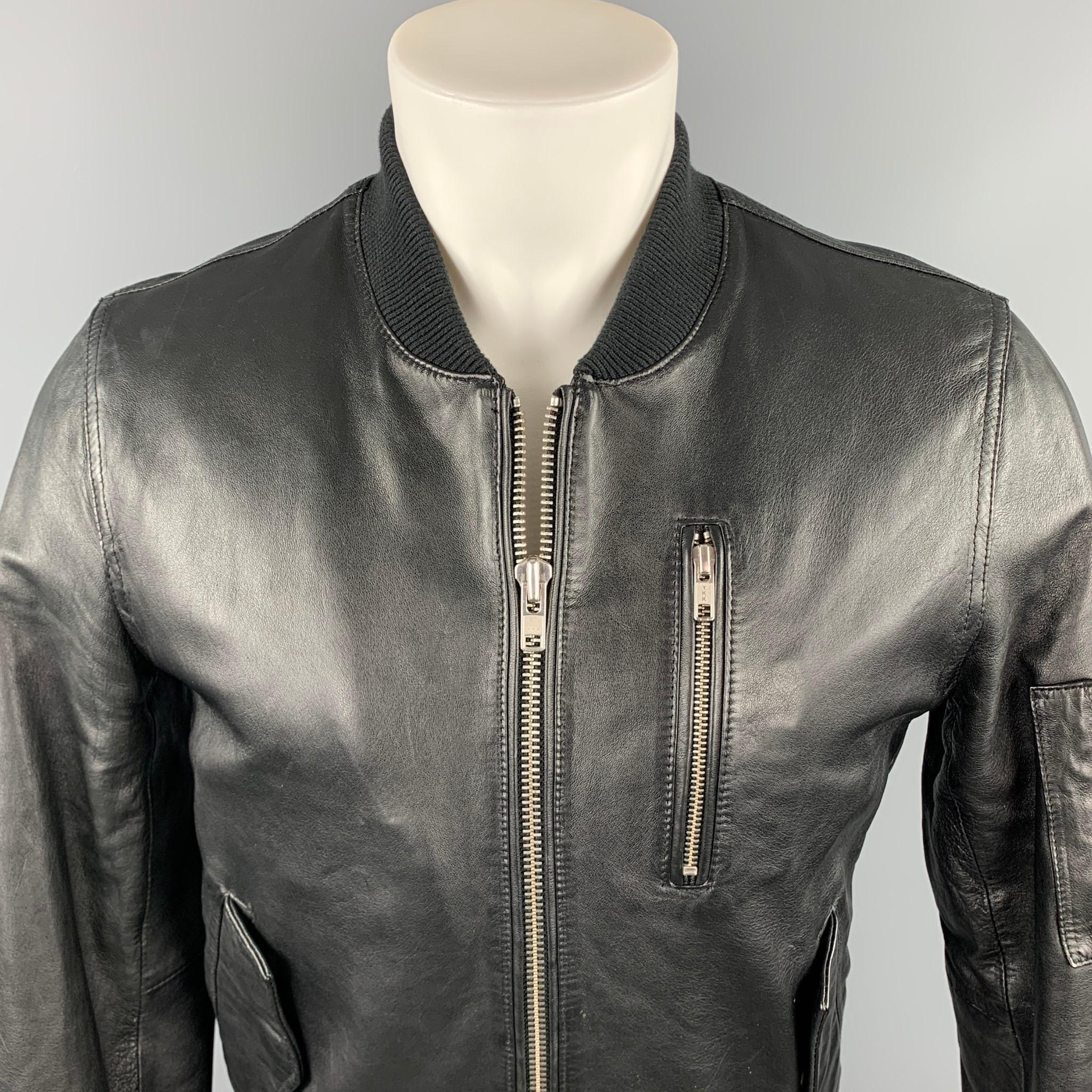 BLK DNM jacket comes in a black leather featuring a bomber style, ribbed hem, zipper pockets, and zip up closure. 

Excellent Pre-Owned Condition.
Marked: S

Measurements:

Shoulder: 17 in. 
Chest: 40 in. 
Sleeve: 29 in. 
Length: 23.5 in. 