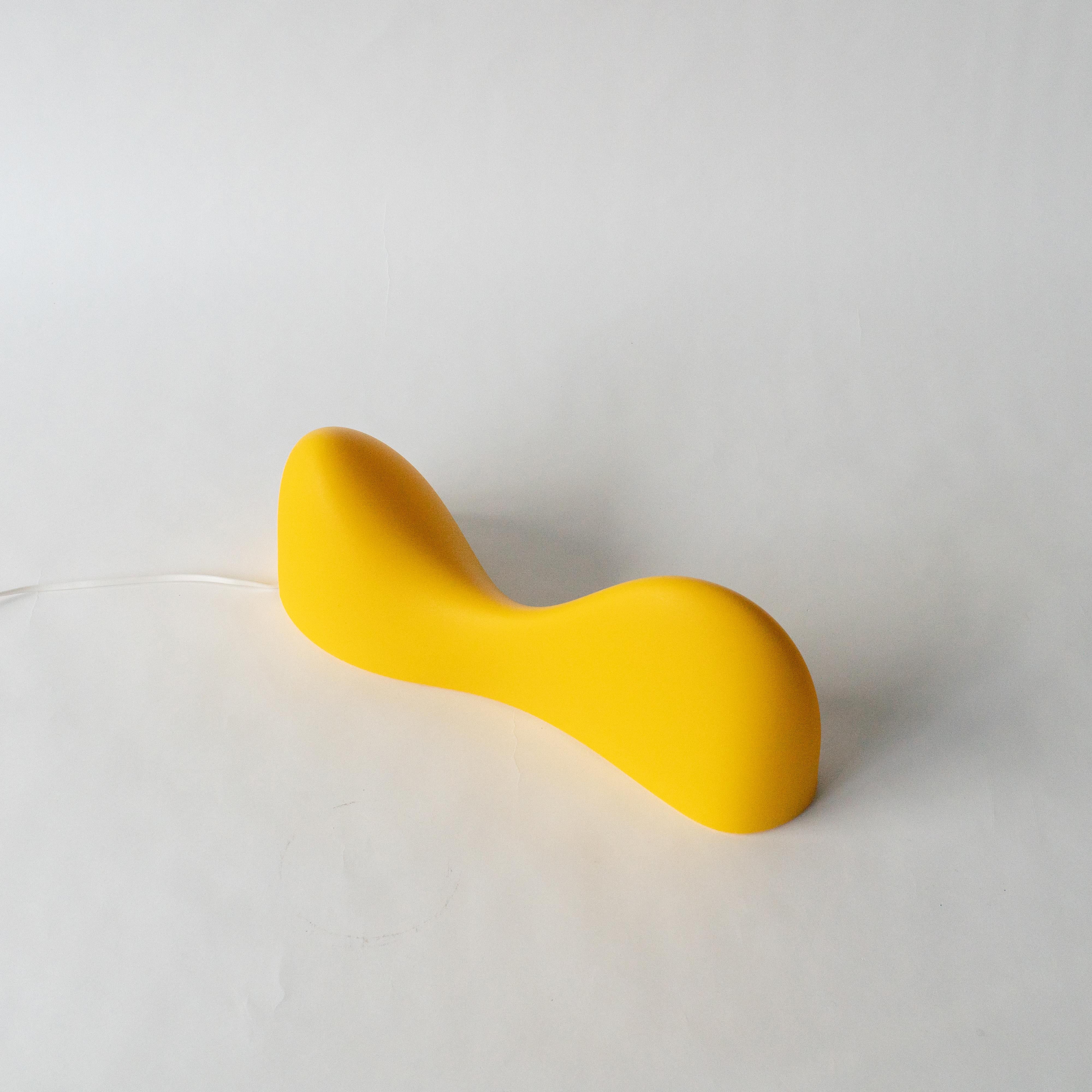 Lampe de table ou applique murale conçue par Karim Rashid. Produit par Foscarini au début des années 2000.
En polypropylène blanc avec vase en acier. Un grand modèle de sol blanc est également disponible.  Cet éclairage est un produit célèbre à